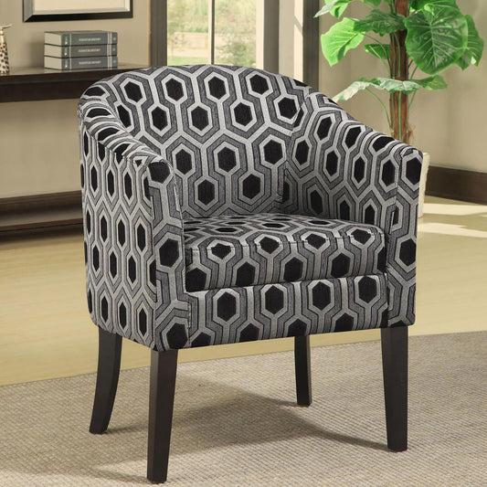 Accent chair with a bold geometric pattern in black and silver fabric