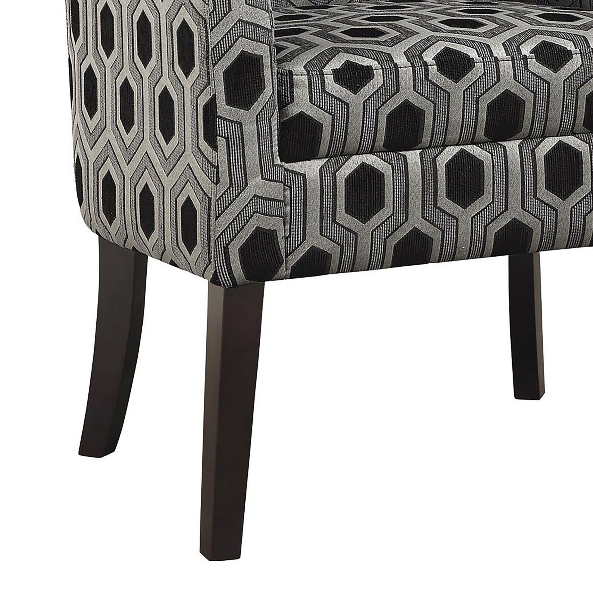 Closeup of a modern accent chair with black and grey geometric hexagon pattern upholstery