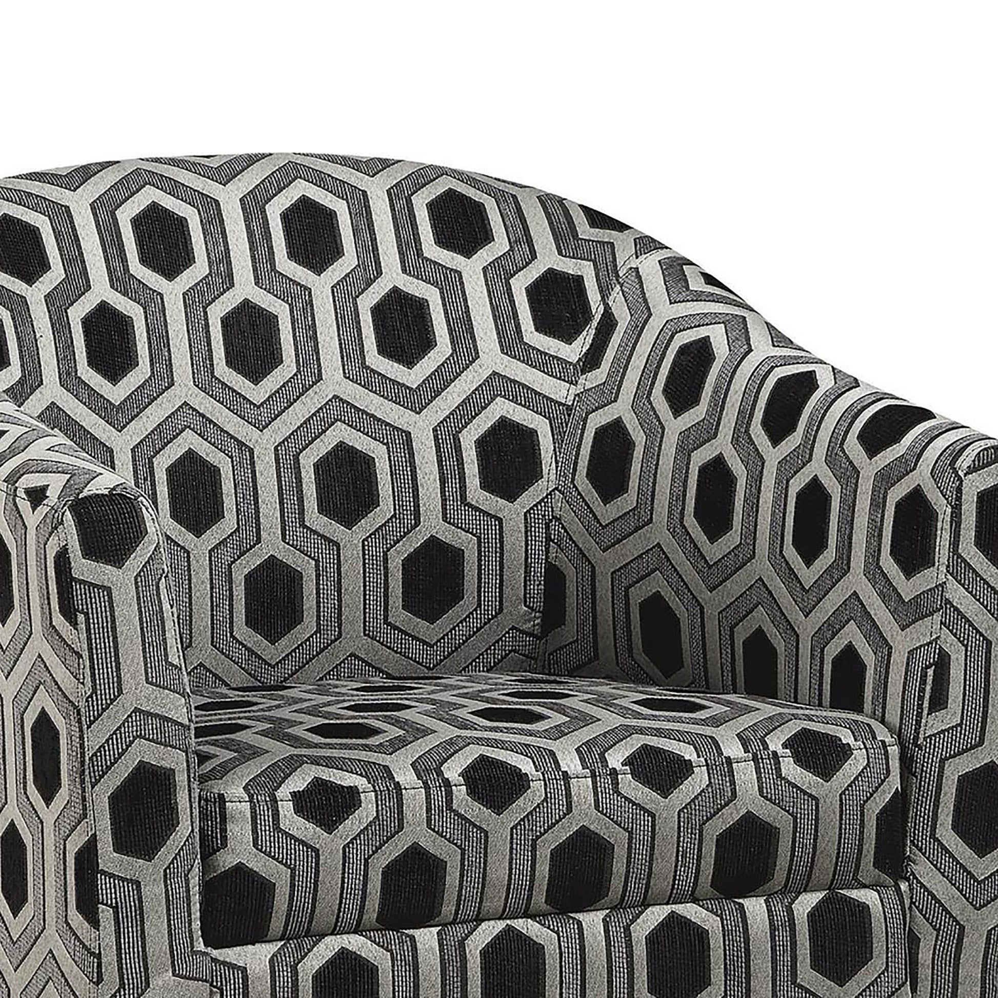 Closeup of a modern barrel chair upholstered in geometric black and grey fabric