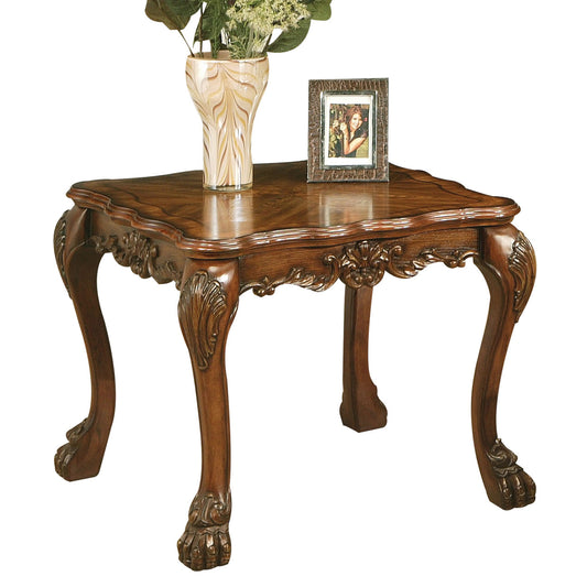 Ornate dark wood end table with cabriole legs and carved details