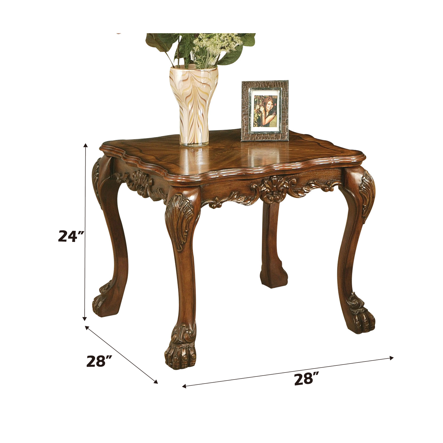 Ornate carved wooden end table with claw feet displaying a decorative vase and picture frame