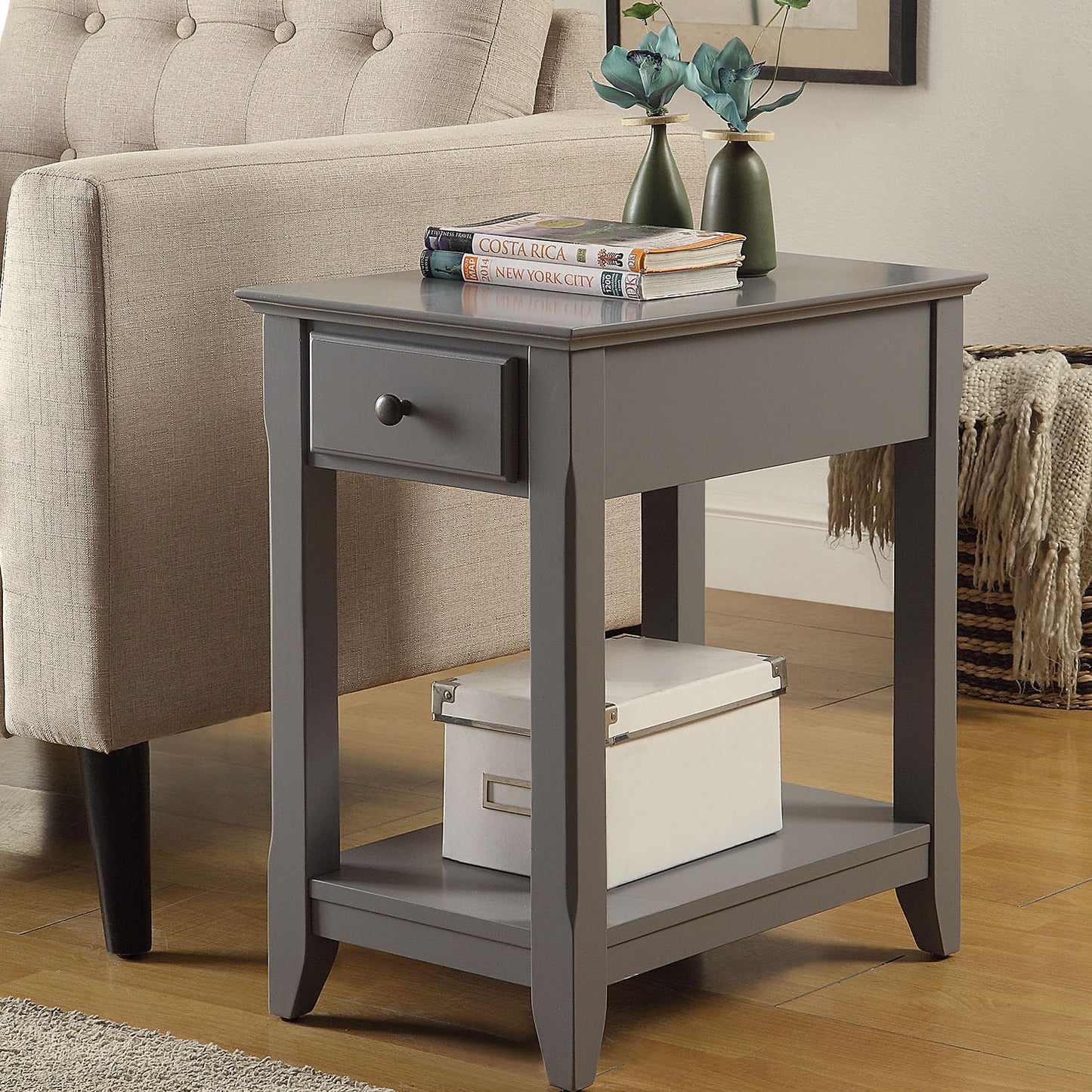 Gray end table with drawer and open shelf next to sofa