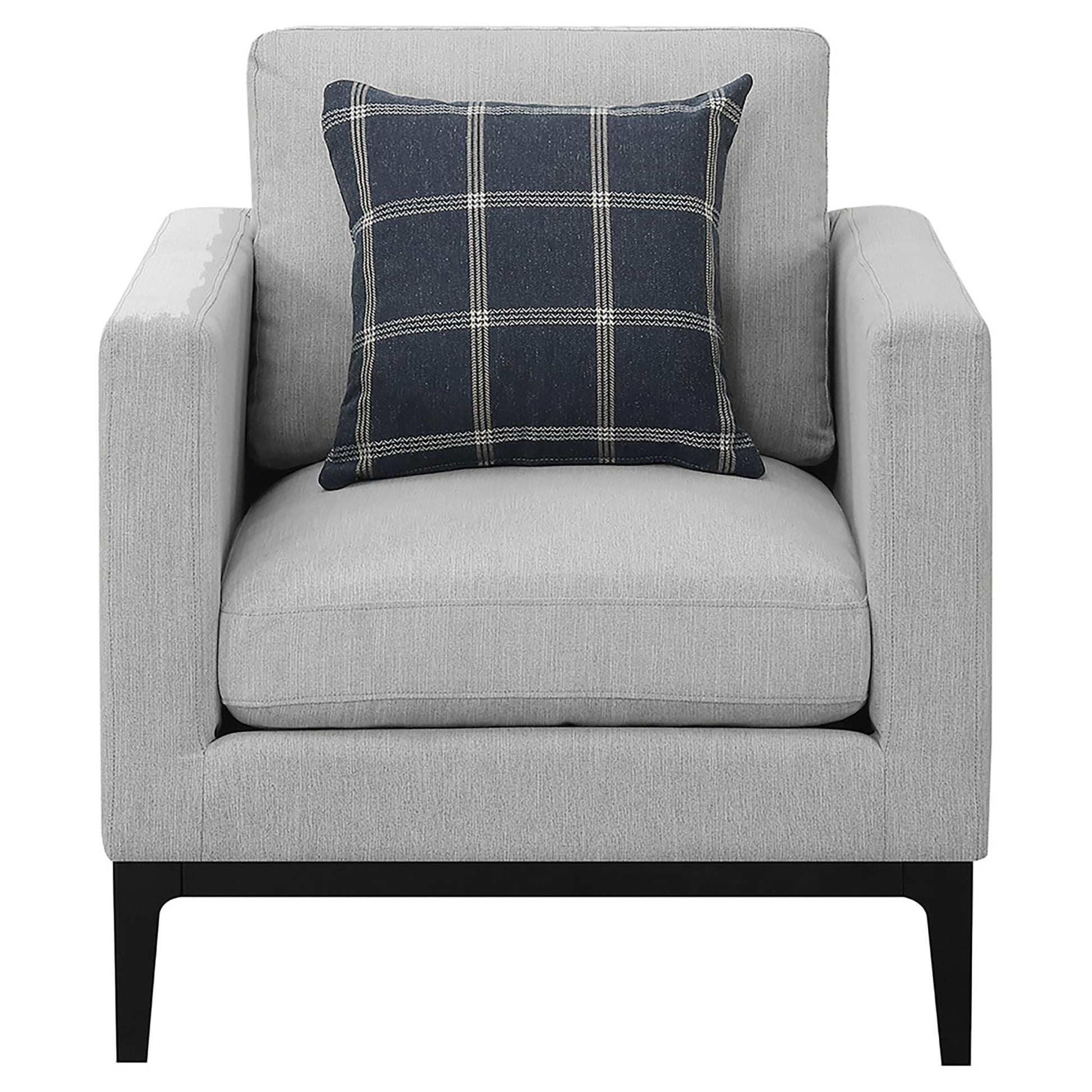 Light gray upholstered armchair with a dark plaid accent pillow and black modern legs