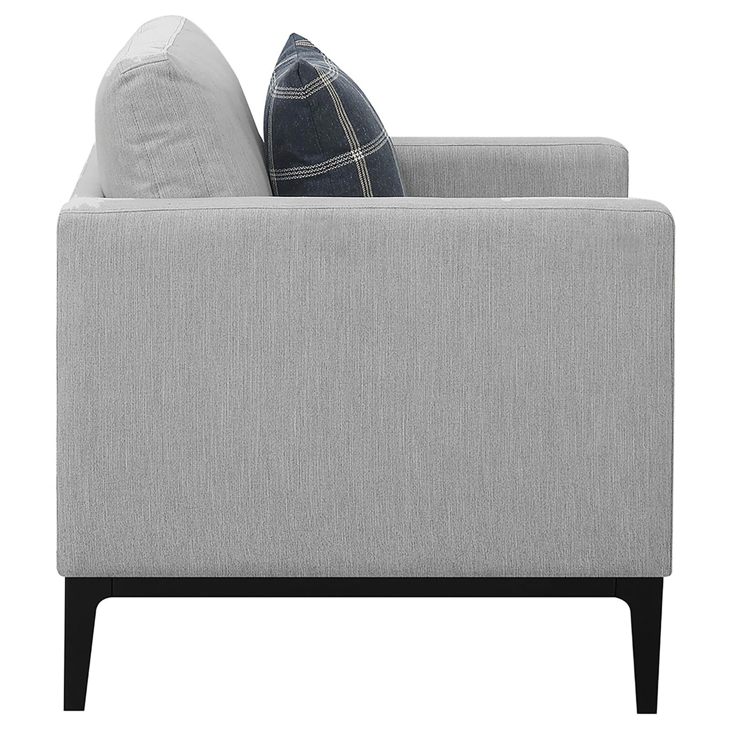 Modern gray fabric sofa with a dark plaid accent pillow and black legs