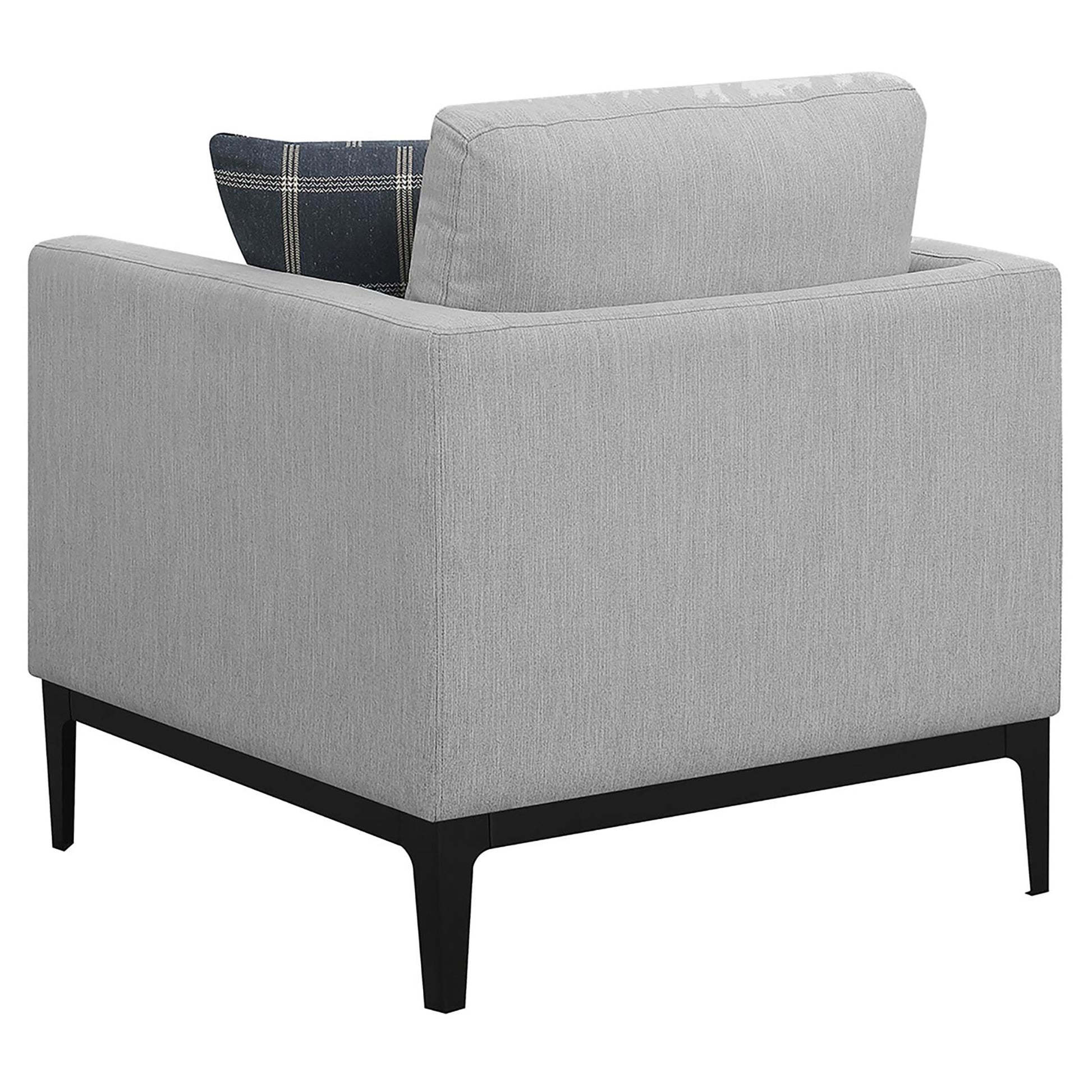 Modern grey fabric armchair with black tapered legs and a patterned accent pillow