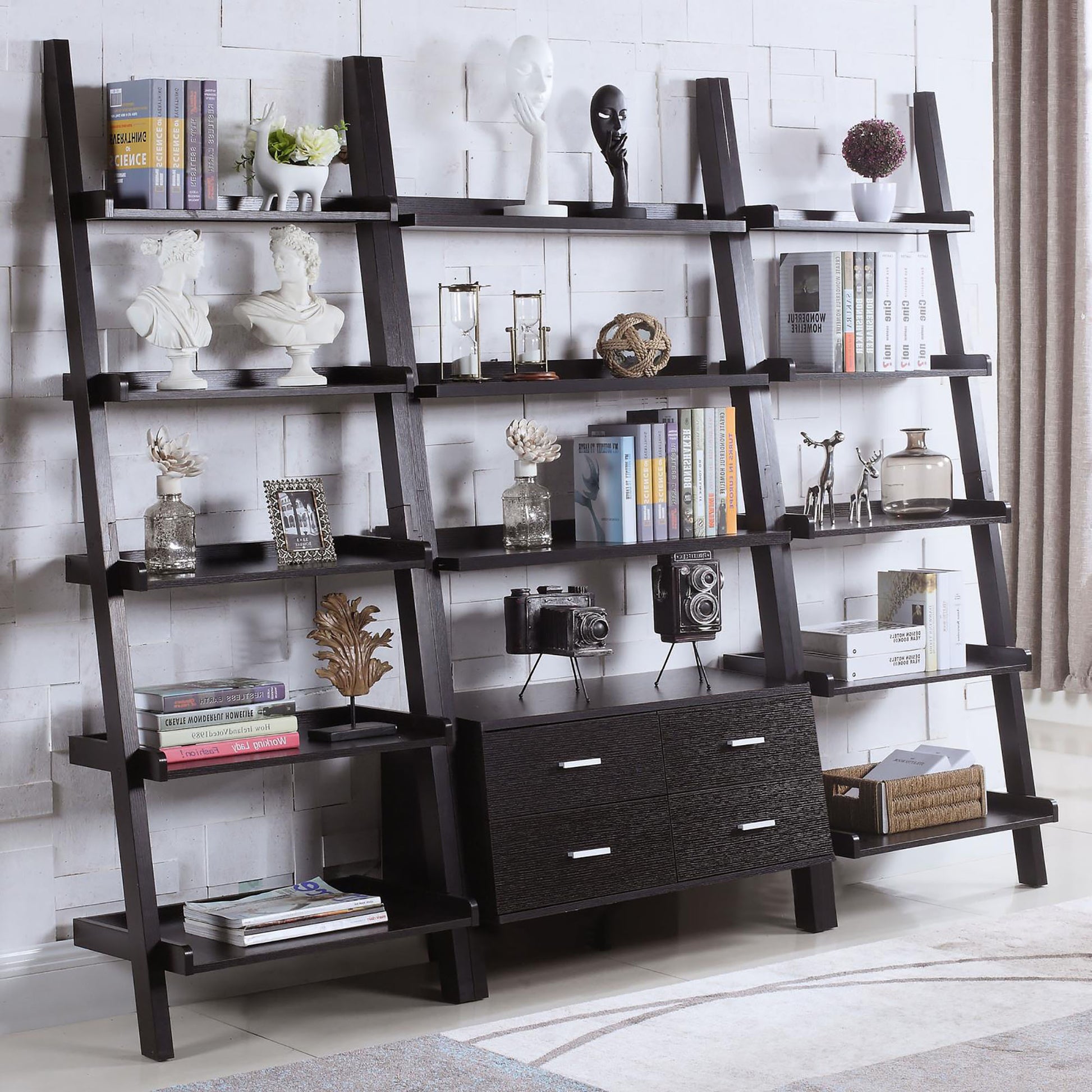 Black ladder bookshelf with decorative busts and books