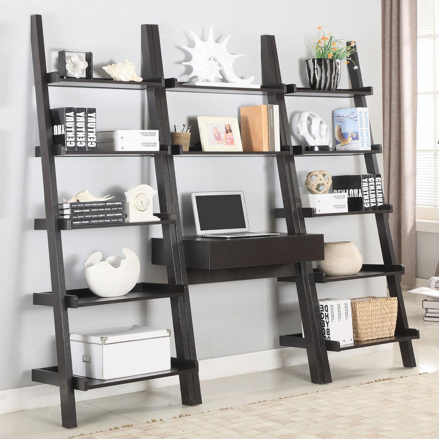 Dark brown ladder bookshelf with multiple shelves and builtin desk