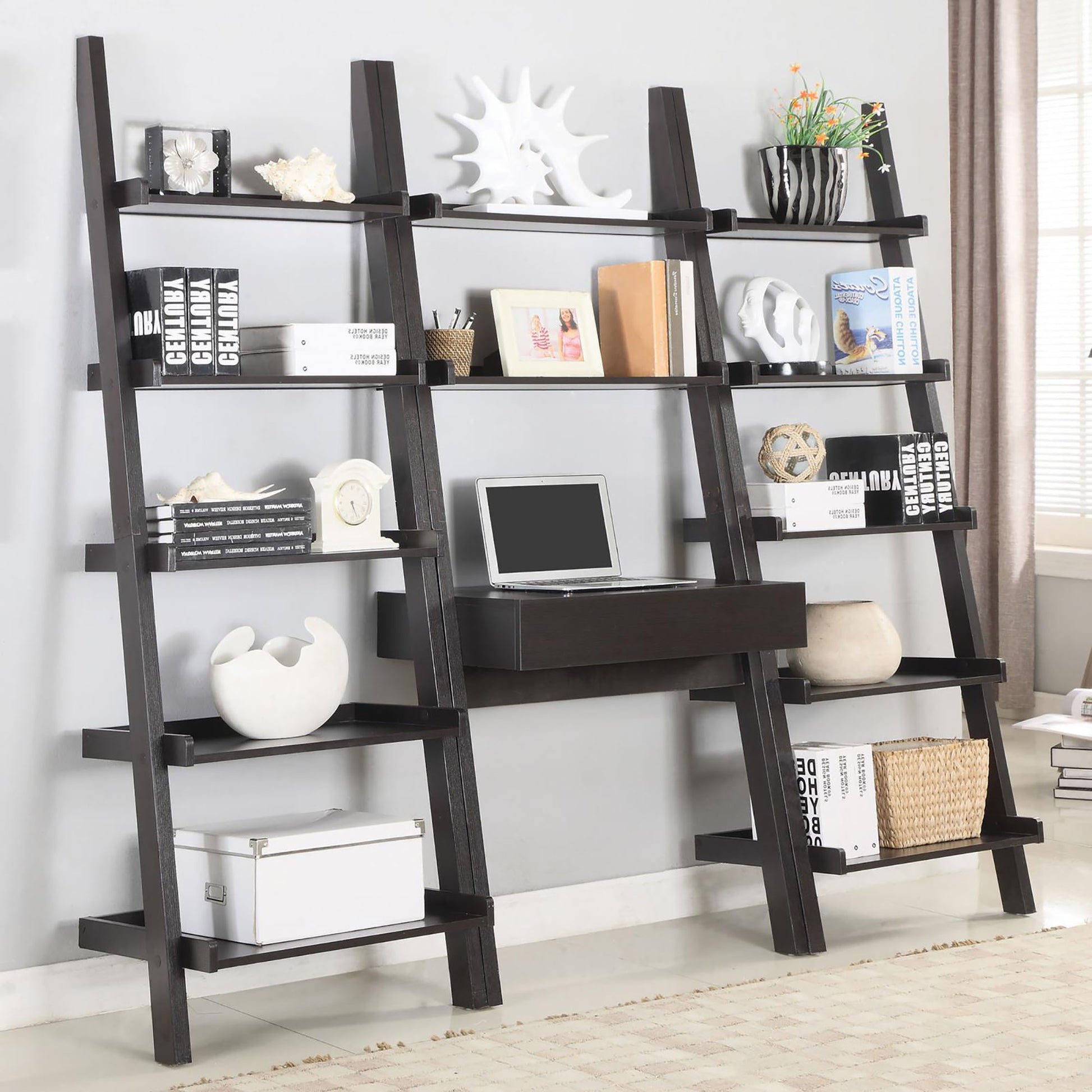 Dark brown ladder bookshelf with multiple shelves and builtin desk