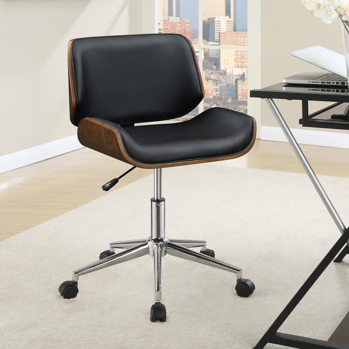 Black leather ergonomic office chair with wood accents and chrome base