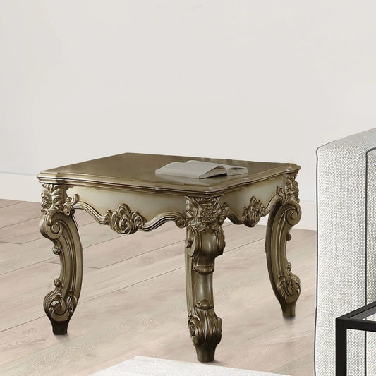 Ornate carved antique end table with a book antique white and gold finish