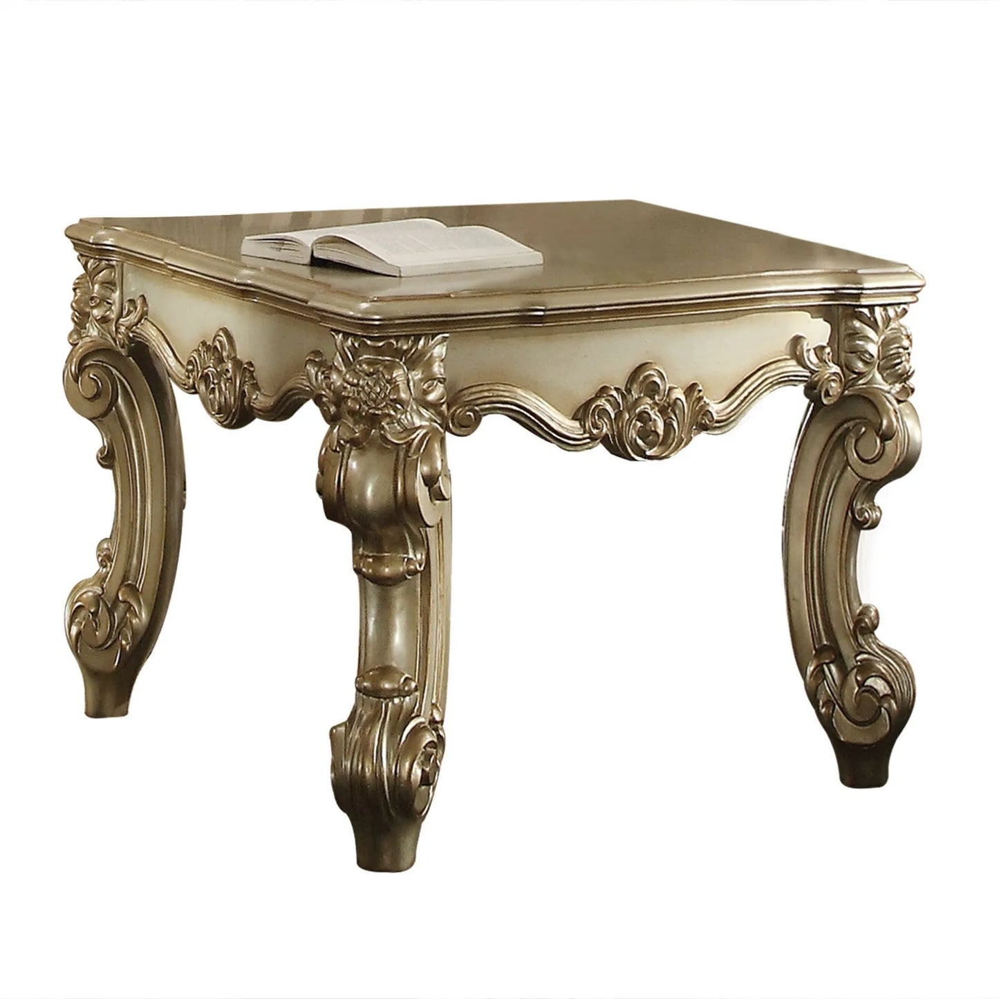 Antique gold ornate square coffee table with carved legs and a book