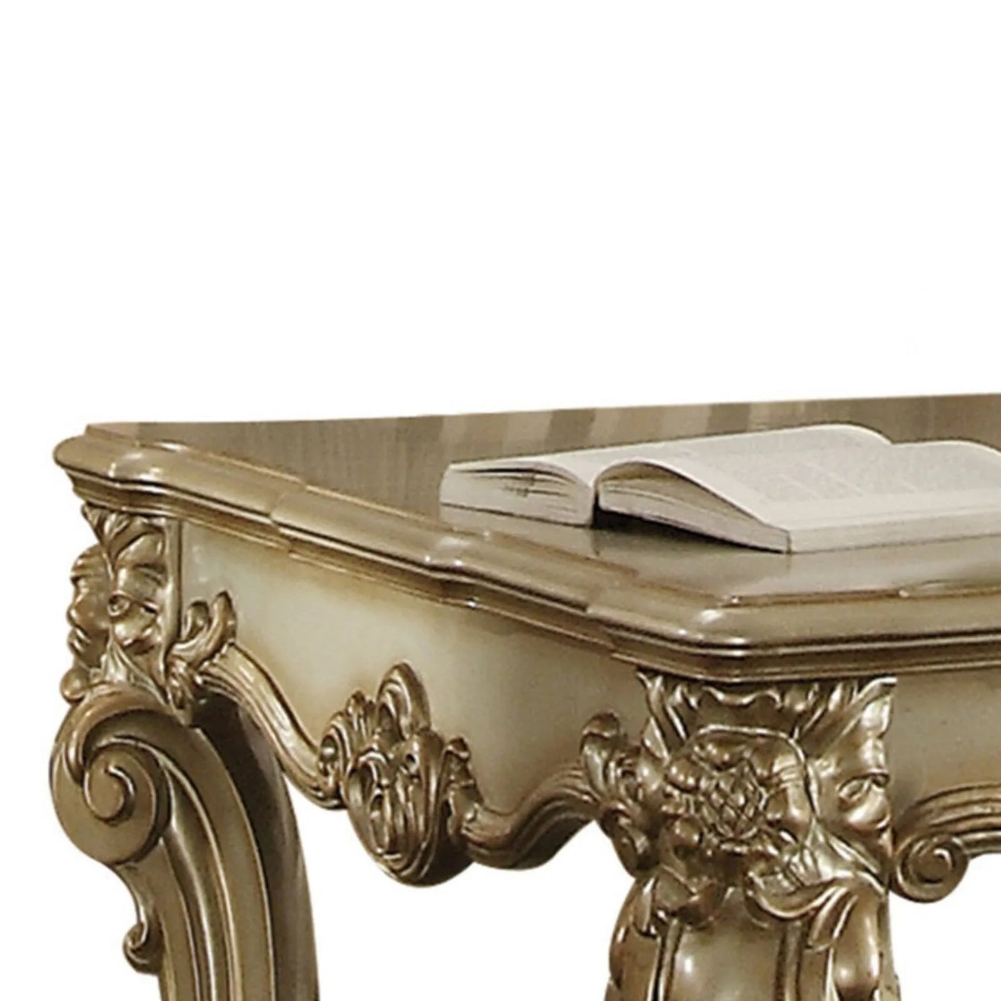 Antique gold carved console table with an open book on its surface