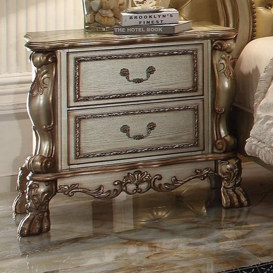 Ornate antique white nightstand with antique brass hardware and ornate legs perfect for a classic bedroom