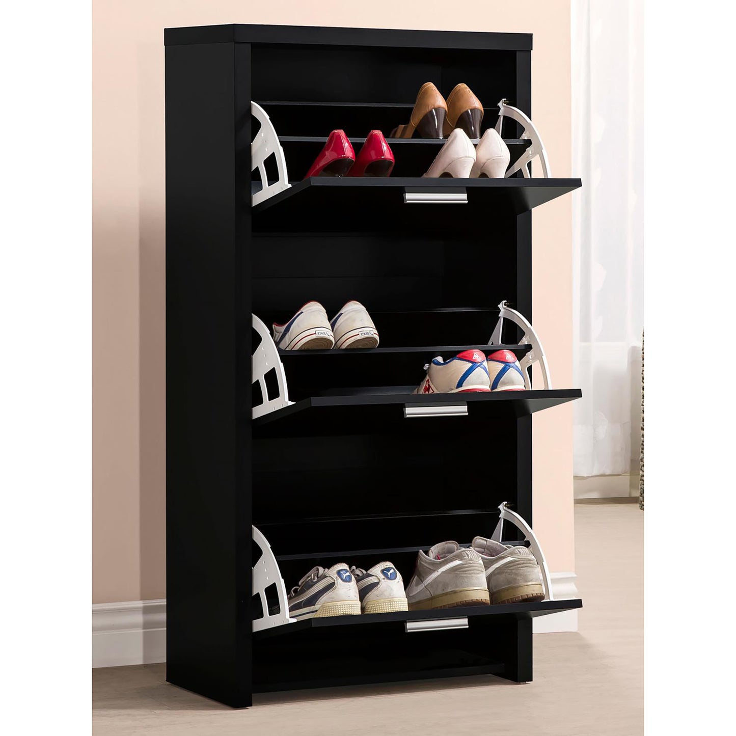 Tall black shoe cabinet with flipdown doors holding various womens heels