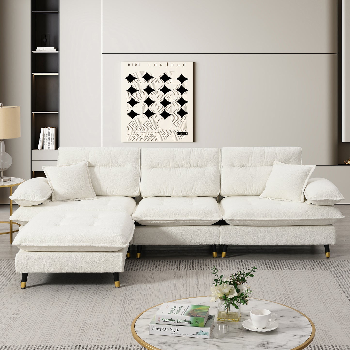 Plush white boucle fabric sectional sofa with goldtipped legs and tufted cushions