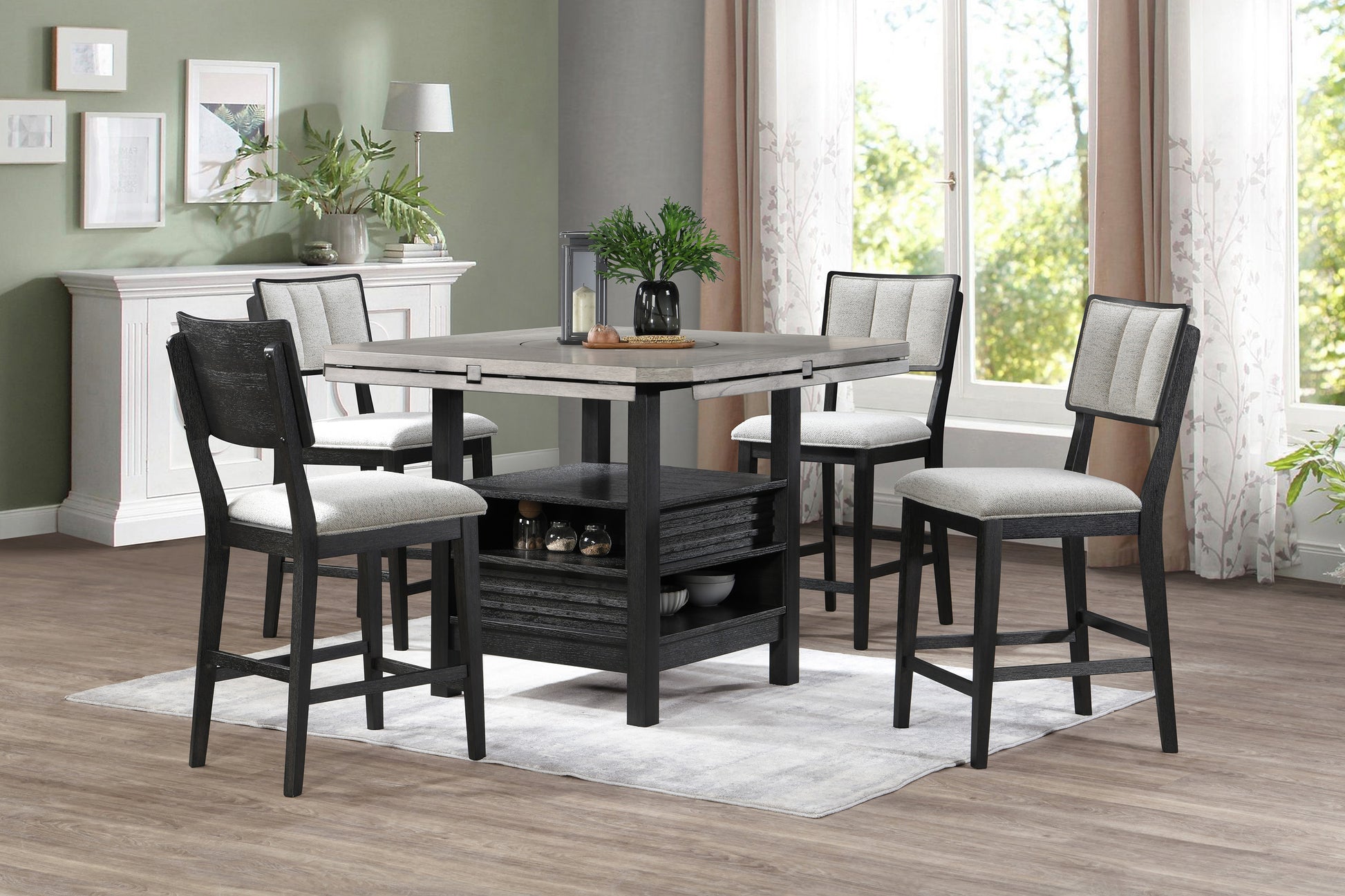 Four modern grey and black counter height chairs with upholstered seats around a dining table