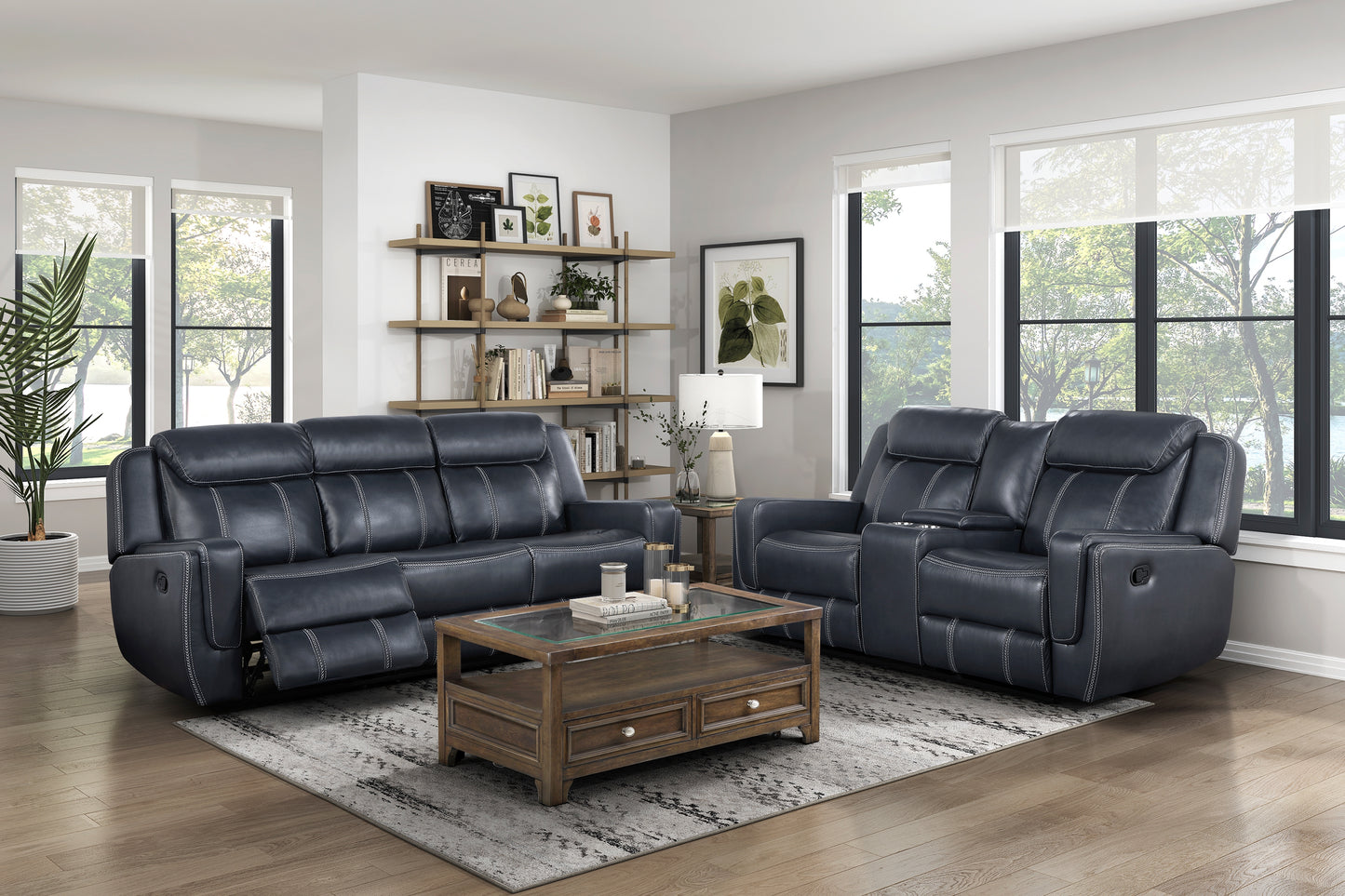 Dark blue leather reclining sofa with white stitching seating for three