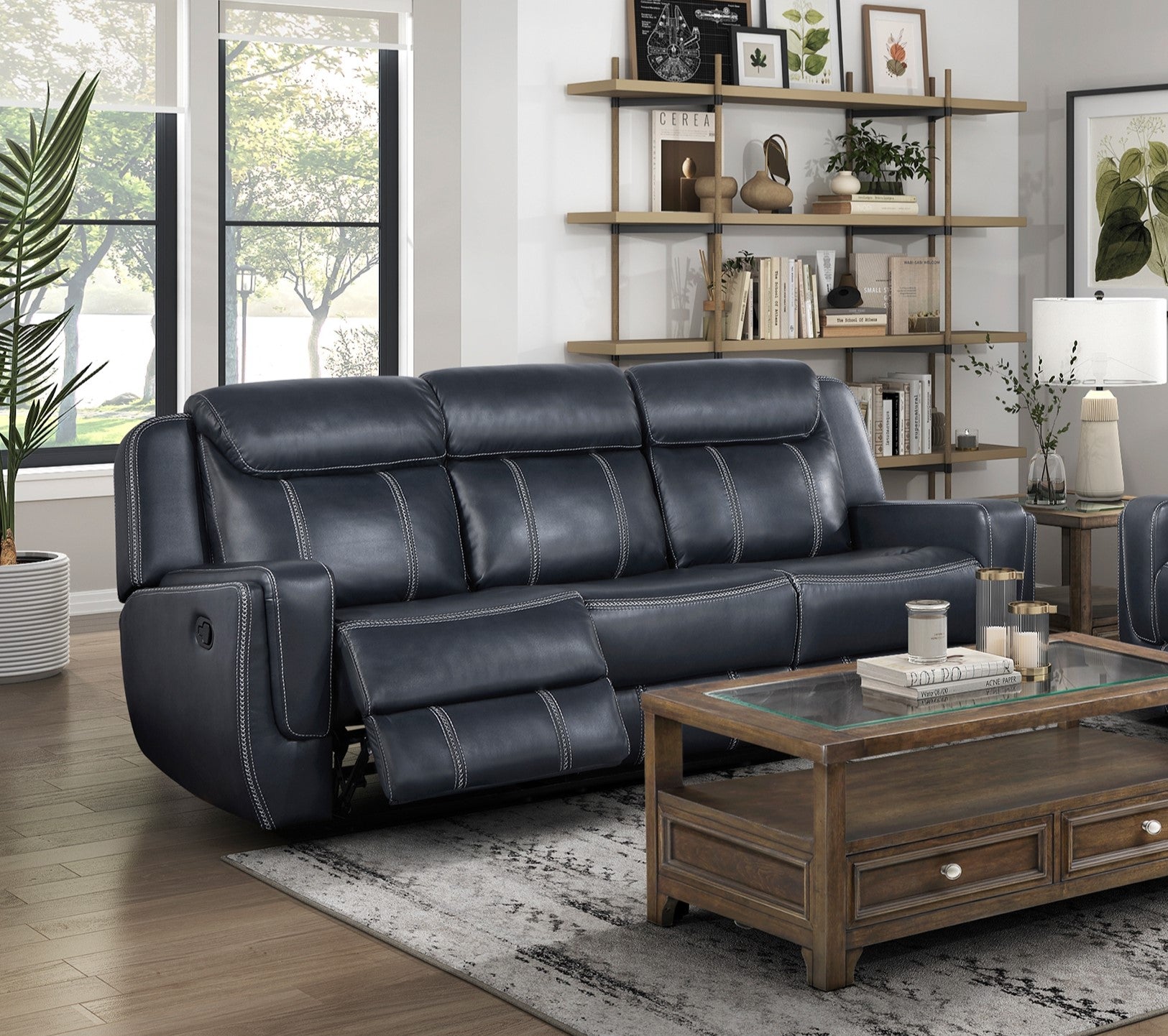 Navy blue leather power recliner sofa with white stitching detail modern living room