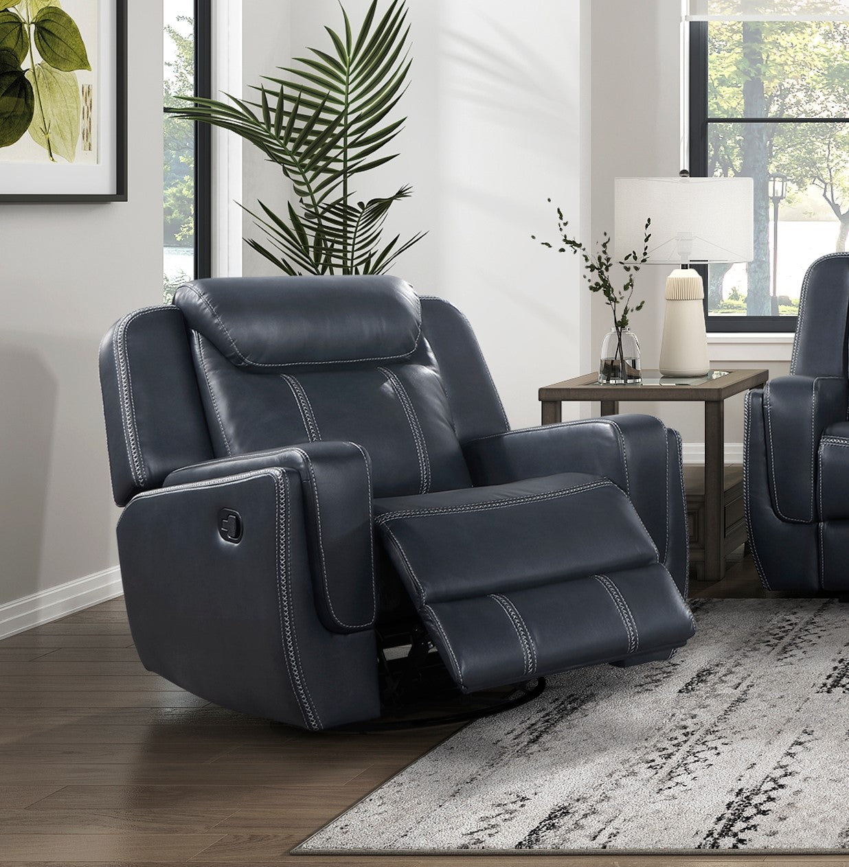 Deep navy leather recliner chair with white stitching offering plush comfort for relaxation
