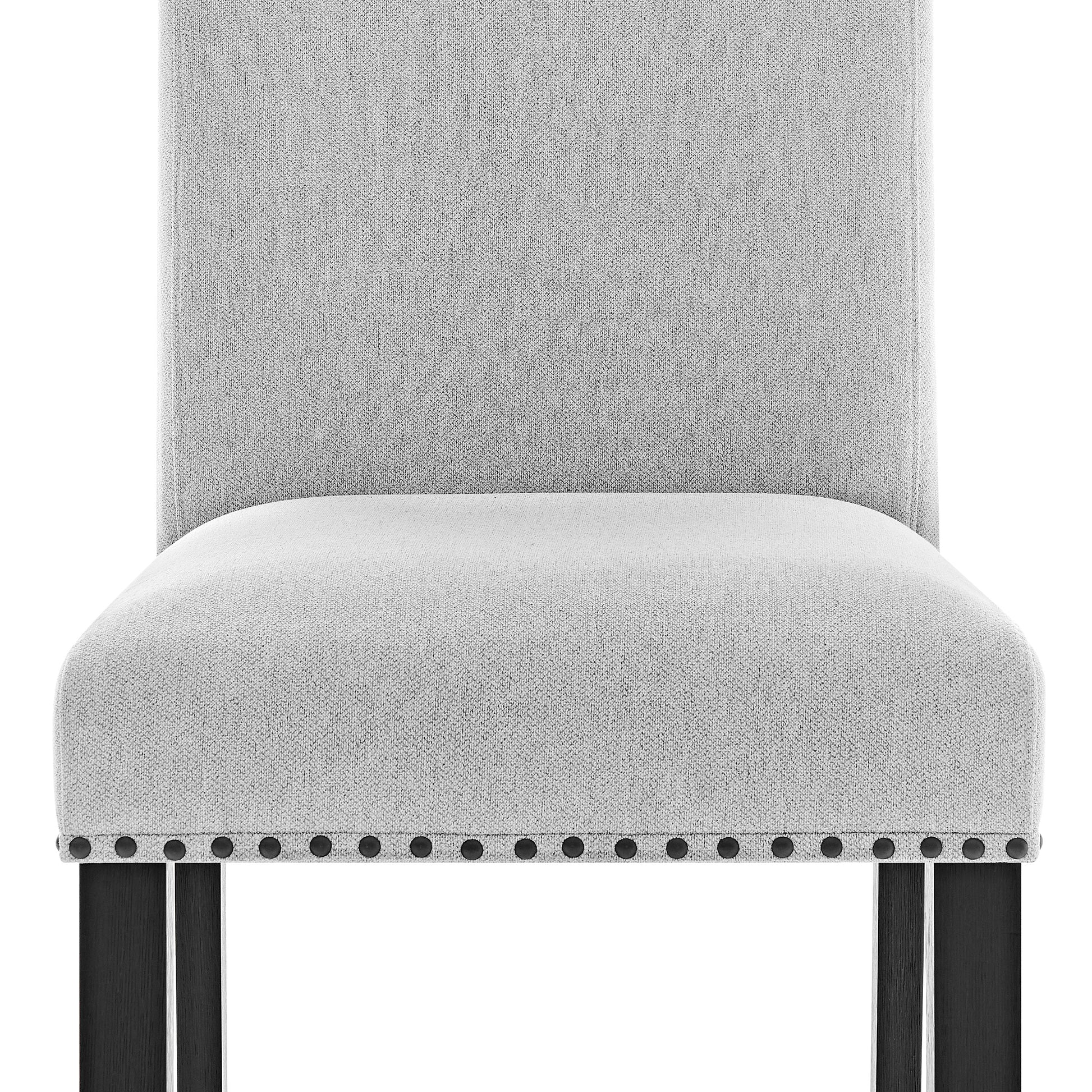 Elegant grey upholstered dining chair with dark wooden legs and stud accents