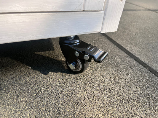 Black swivel caster wheel with brake for furniture mobility and secure placement