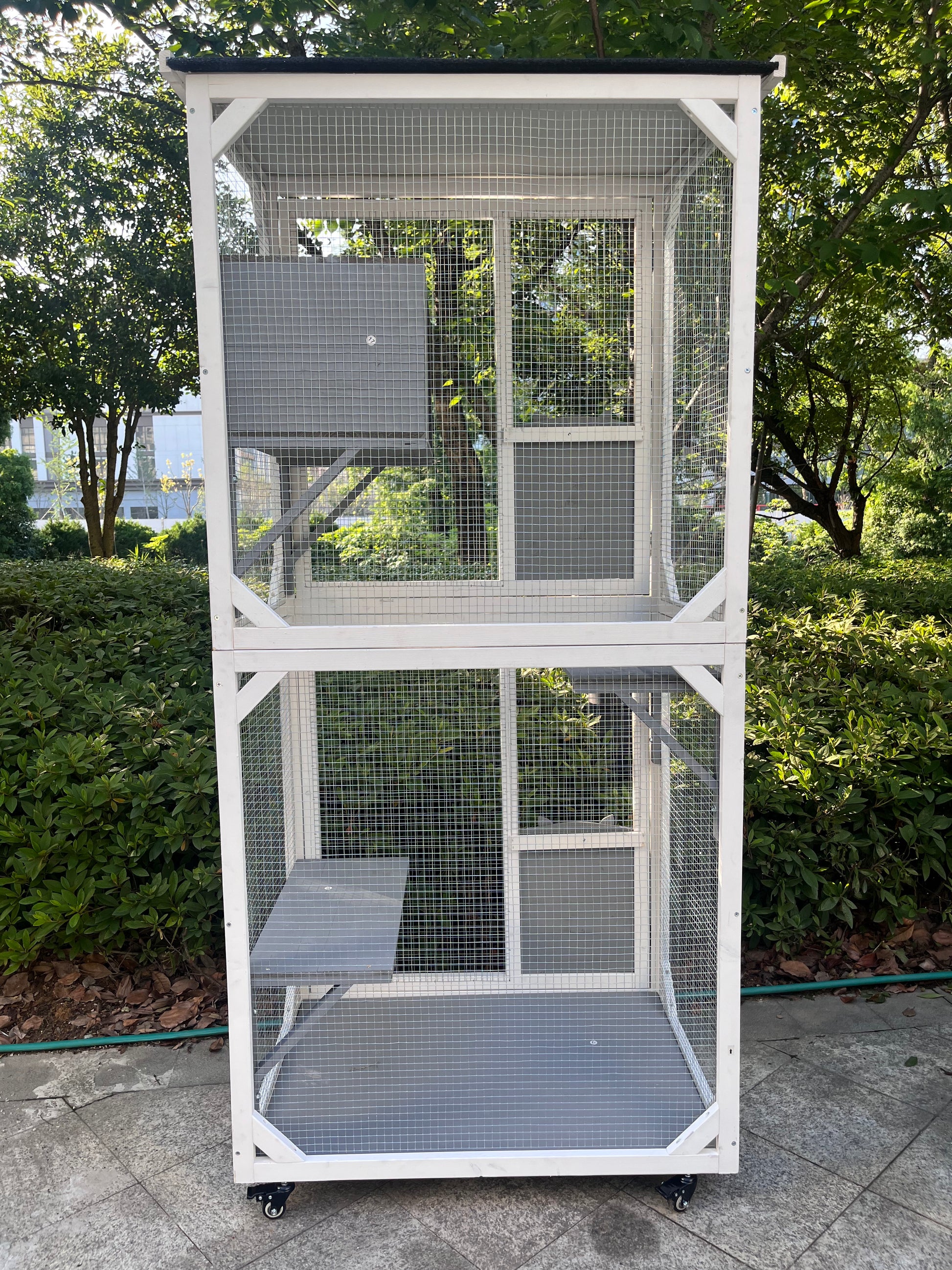 Twotier white outdoor cat enclosure with platforms and wheels