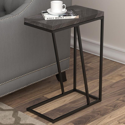 Modern Ctable with dark wood finish top and black metal frame holding a book and mug