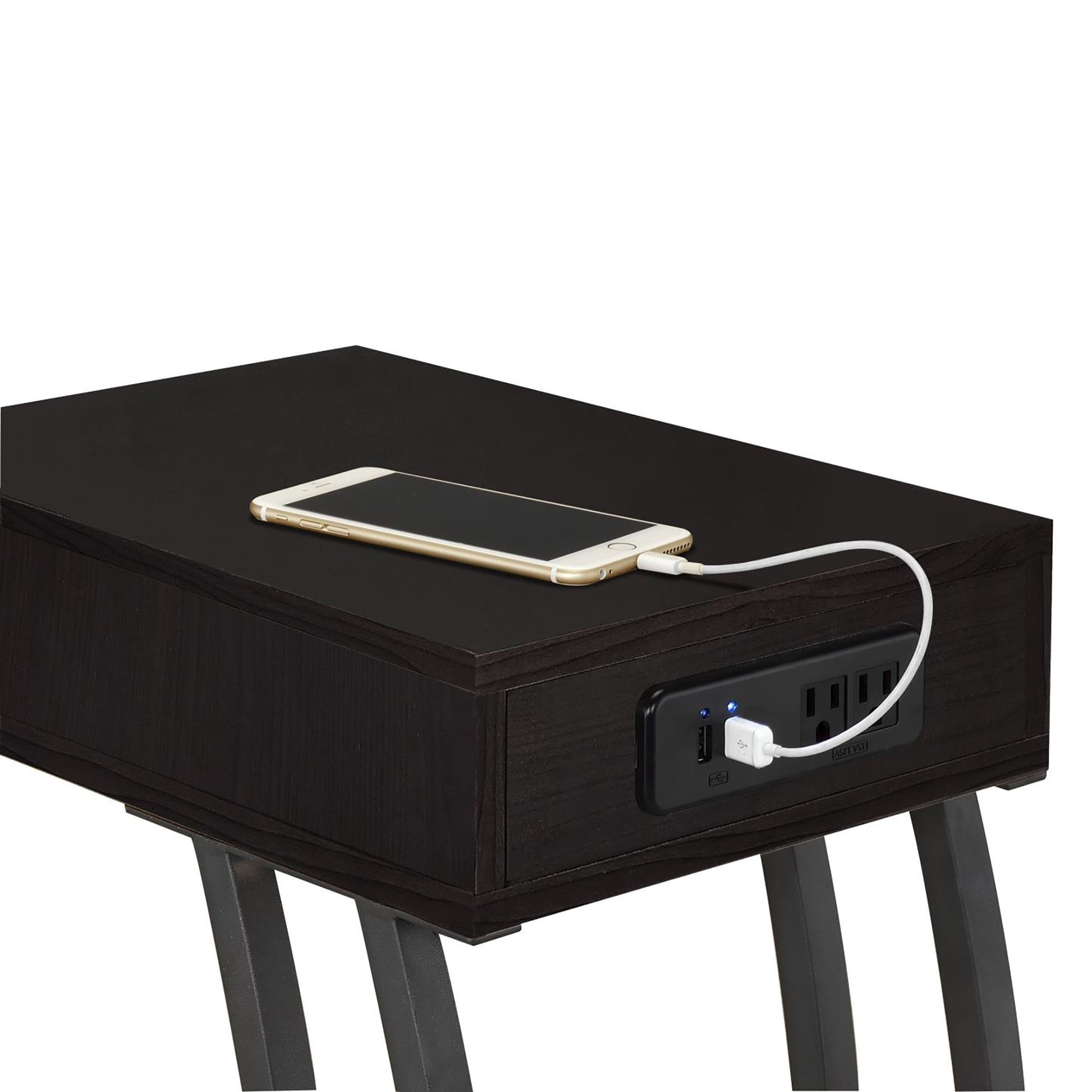Dark wood end table with builtin USB charging ports and outlets holding a smartphone
