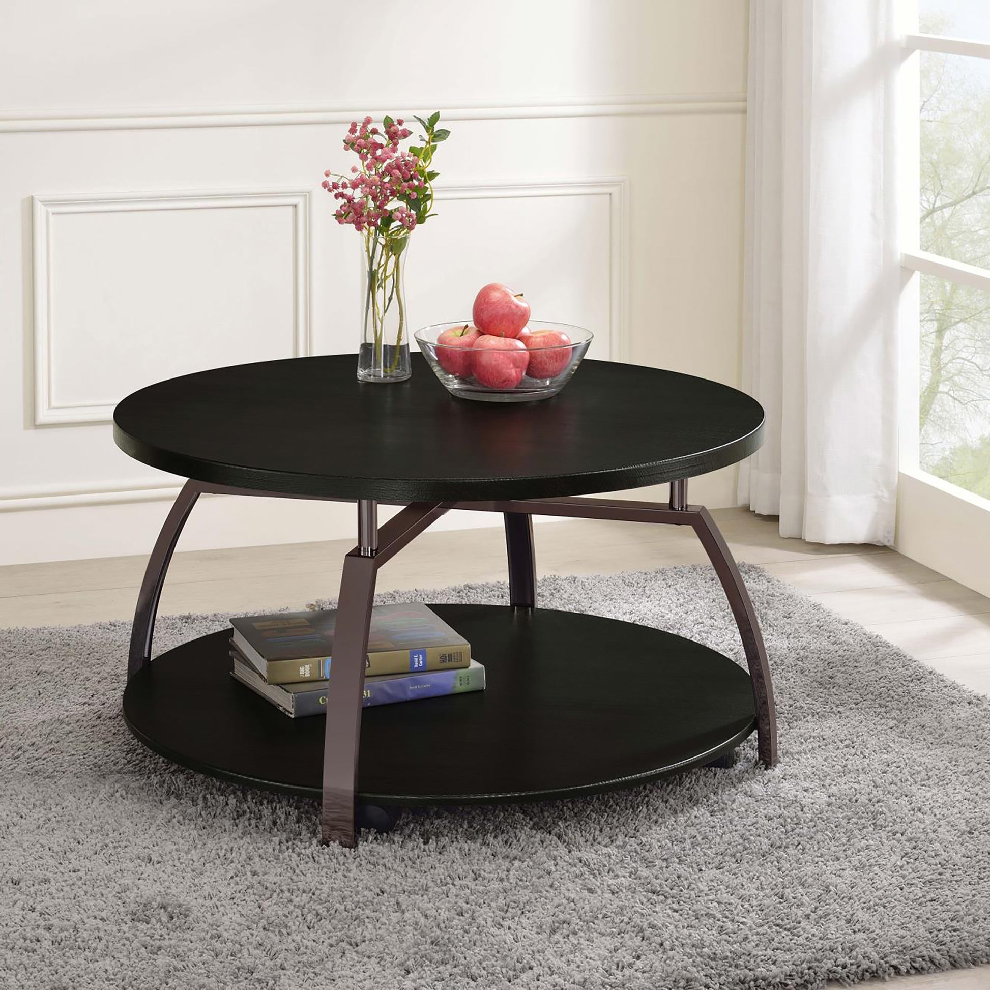Round black coffee table with two tiers and metal legs perfect for living rooms