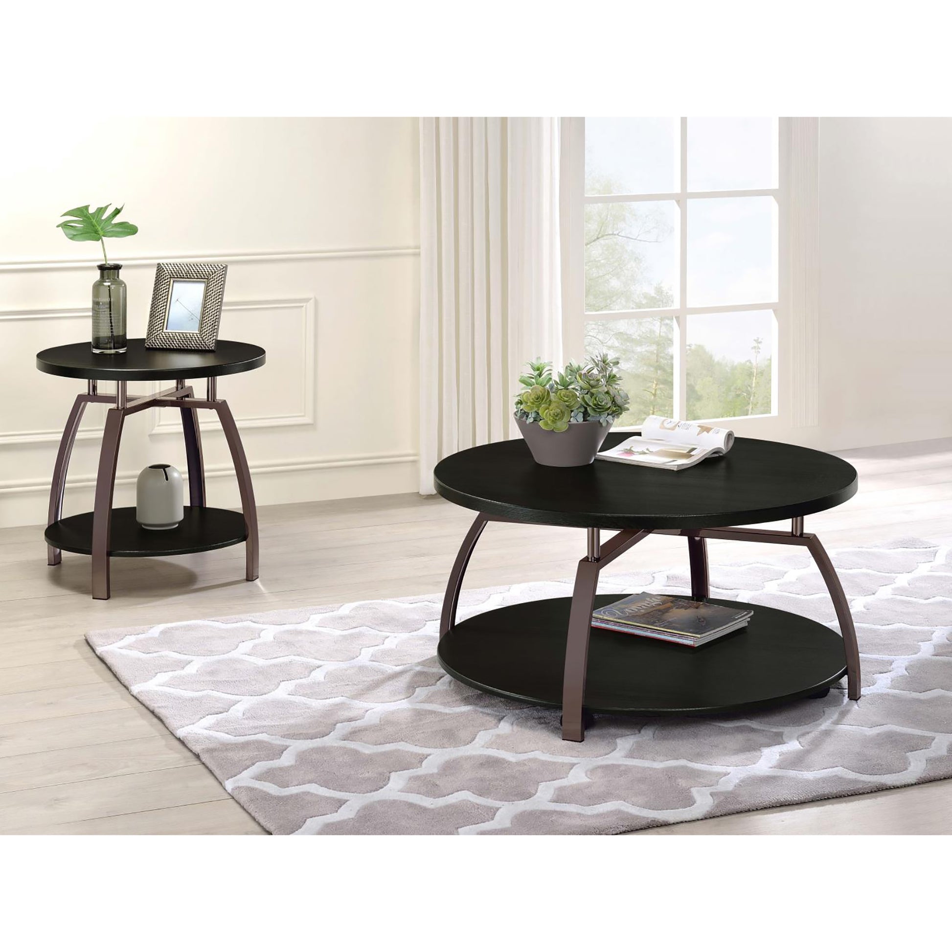 Round black coffee table with metal legs and lower shelf for magazines