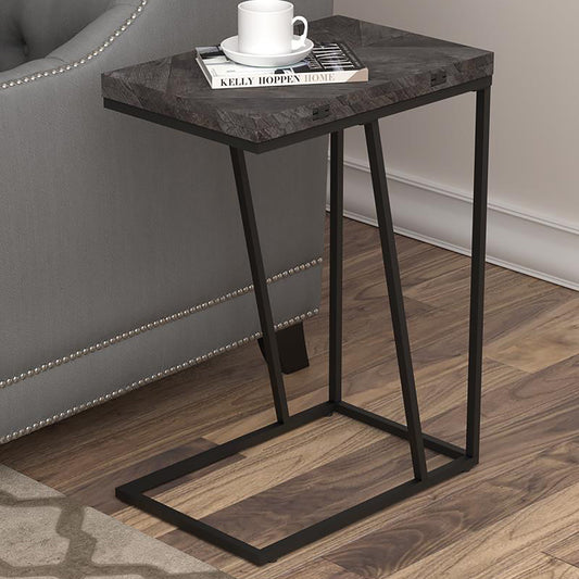 Dark wood ctable with black metal legs holding a coffee mug and book
