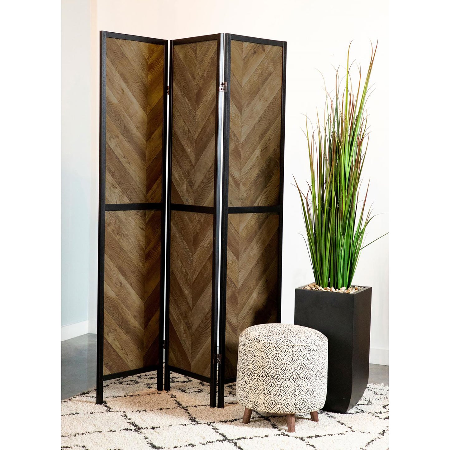 Threepanel room divider with rustic wood herringbone pattern and black metal frame