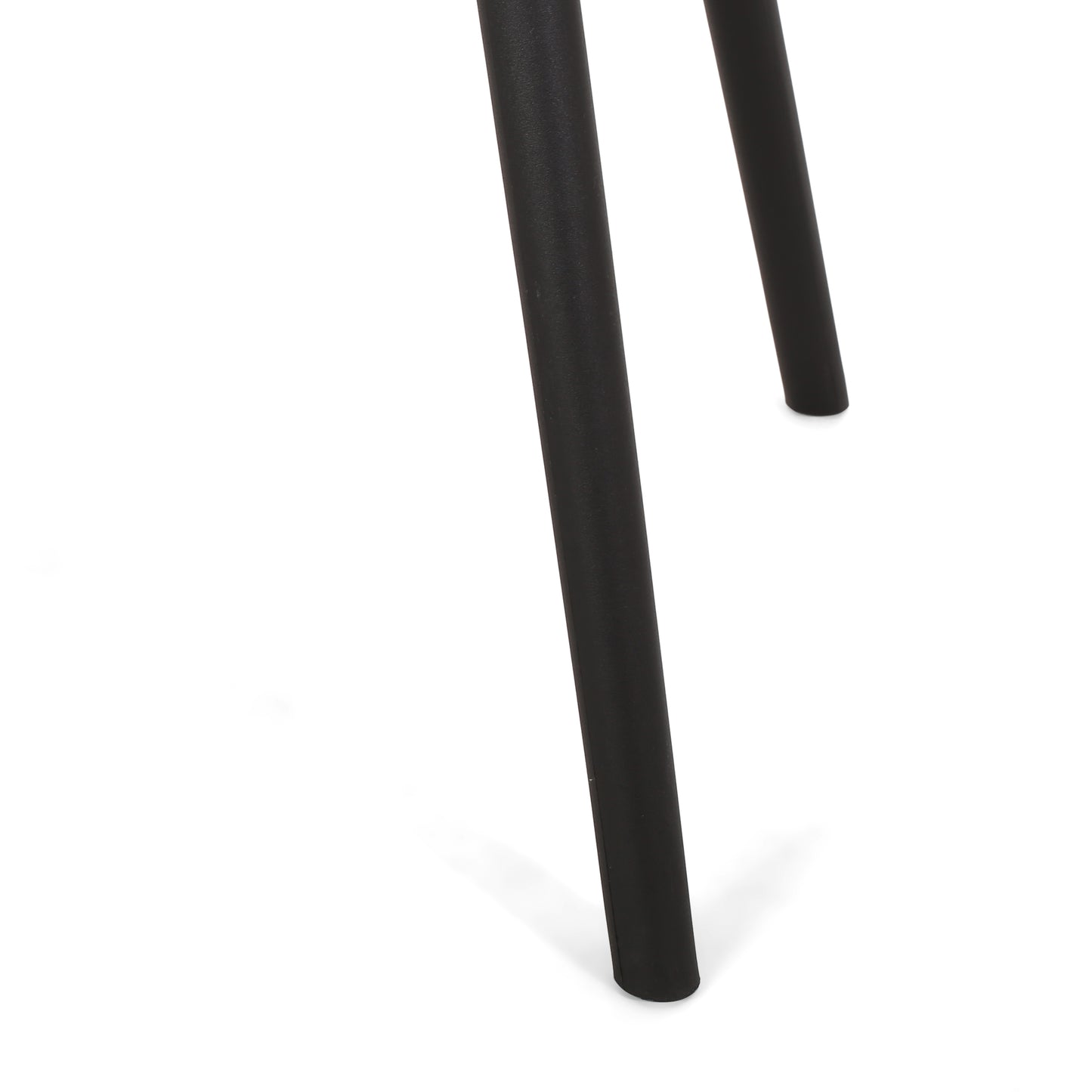 Closeup of matte black metal table legs with modern tapered design