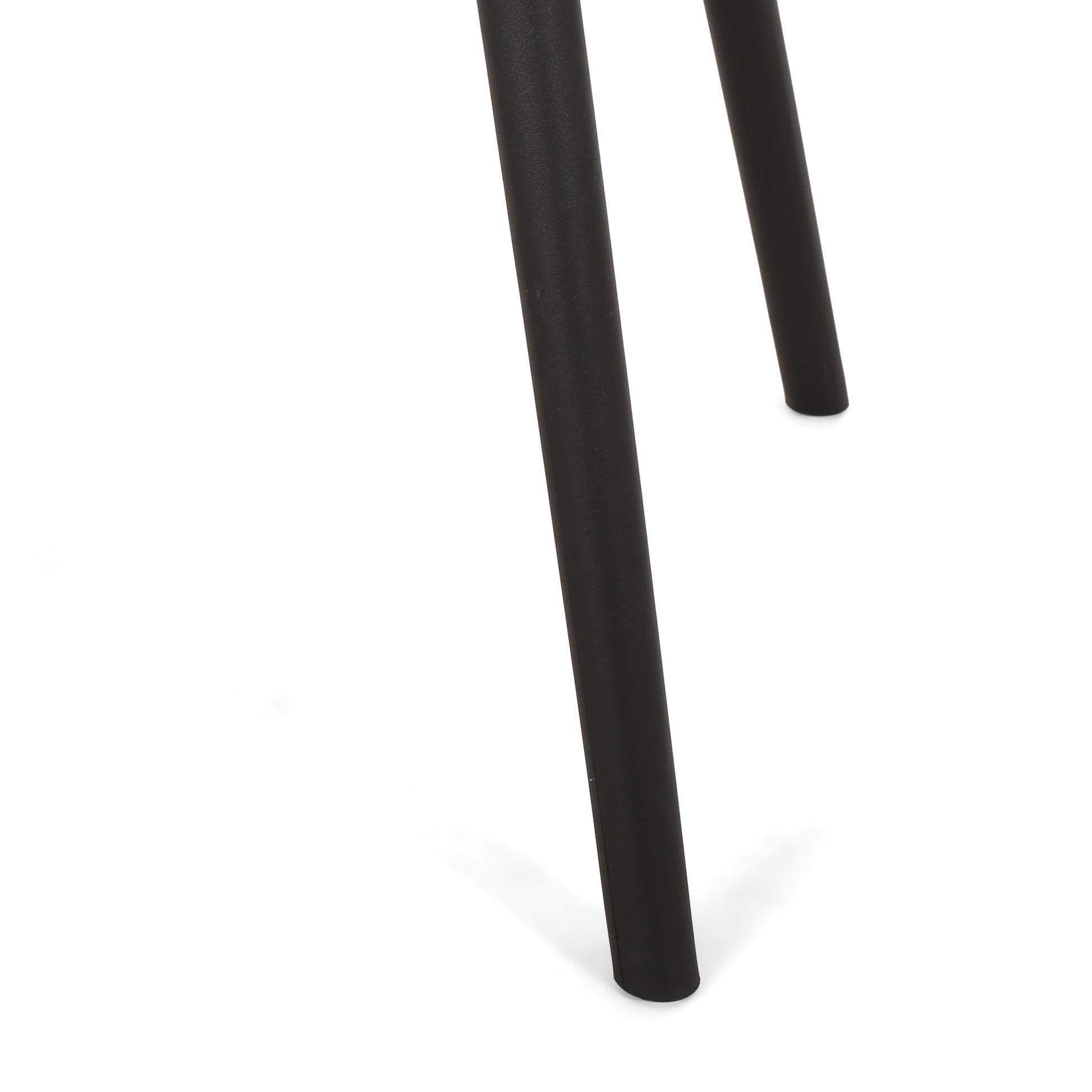 Closeup of matte black metal table legs with modern tapered design