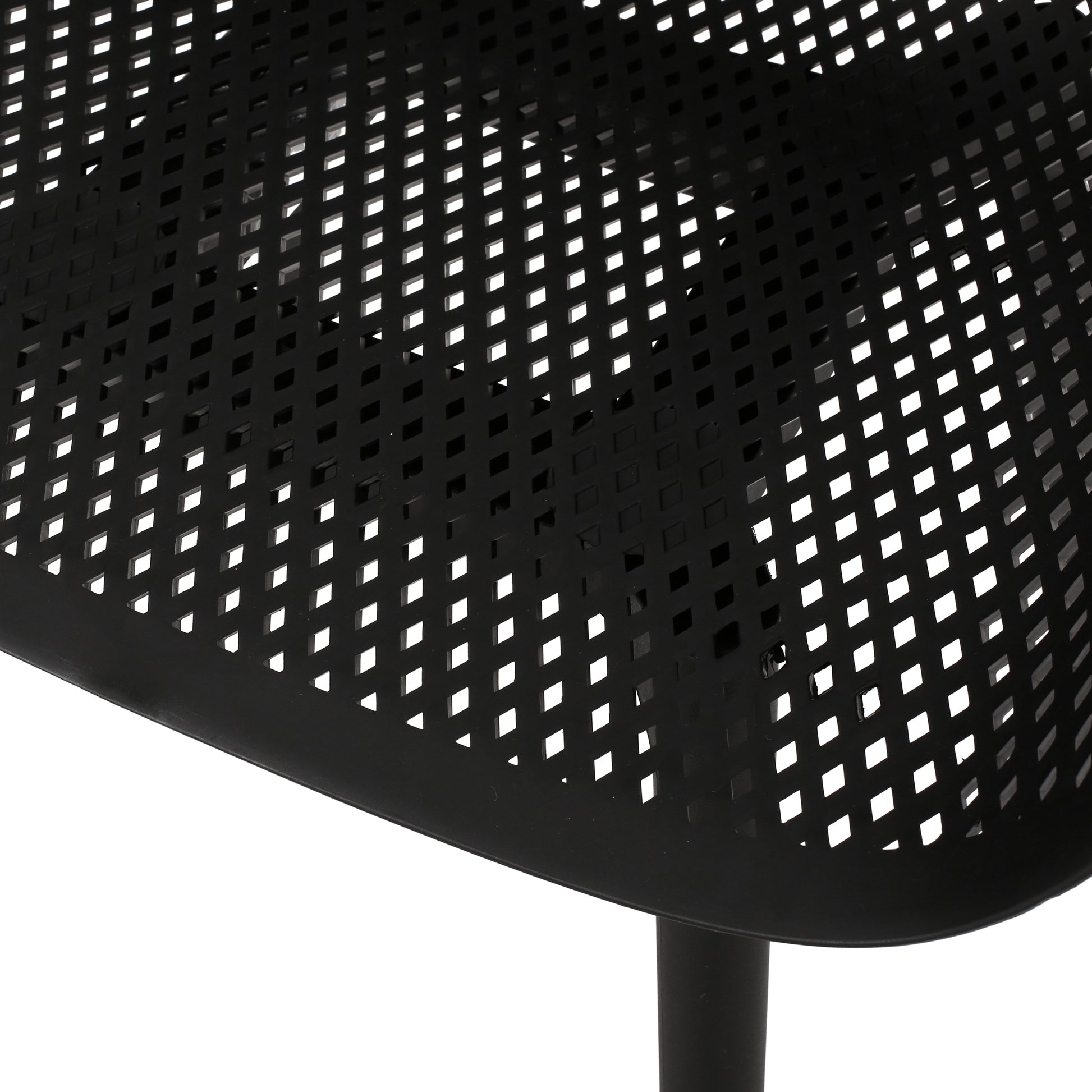 Closeup of a black metal patio chair seat with a diamondshaped perforated pattern