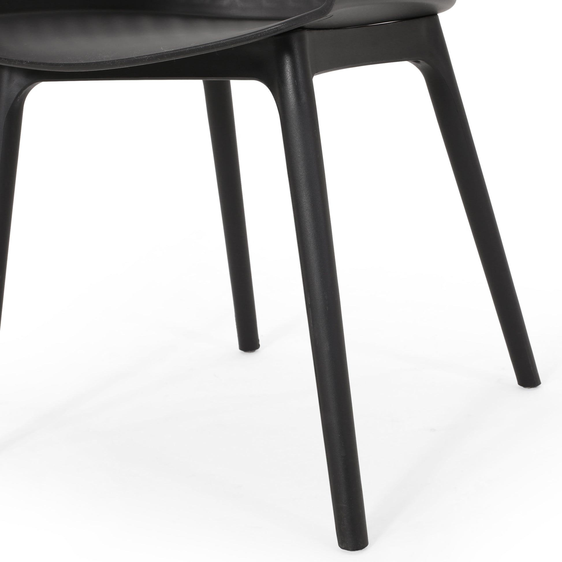 Black modern chair with four tapered legs on white background