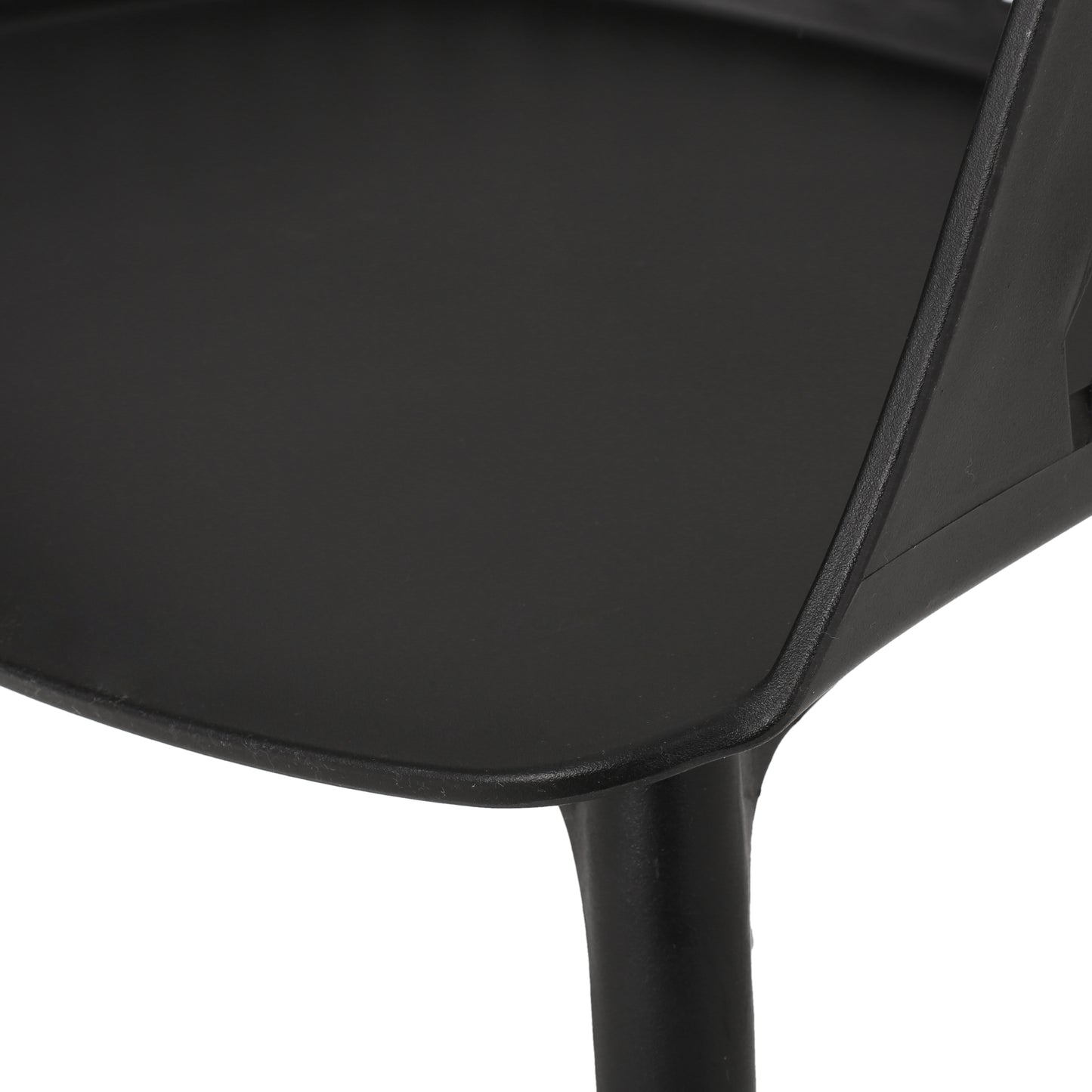 Closeup of a black plastic modern chair seat edge