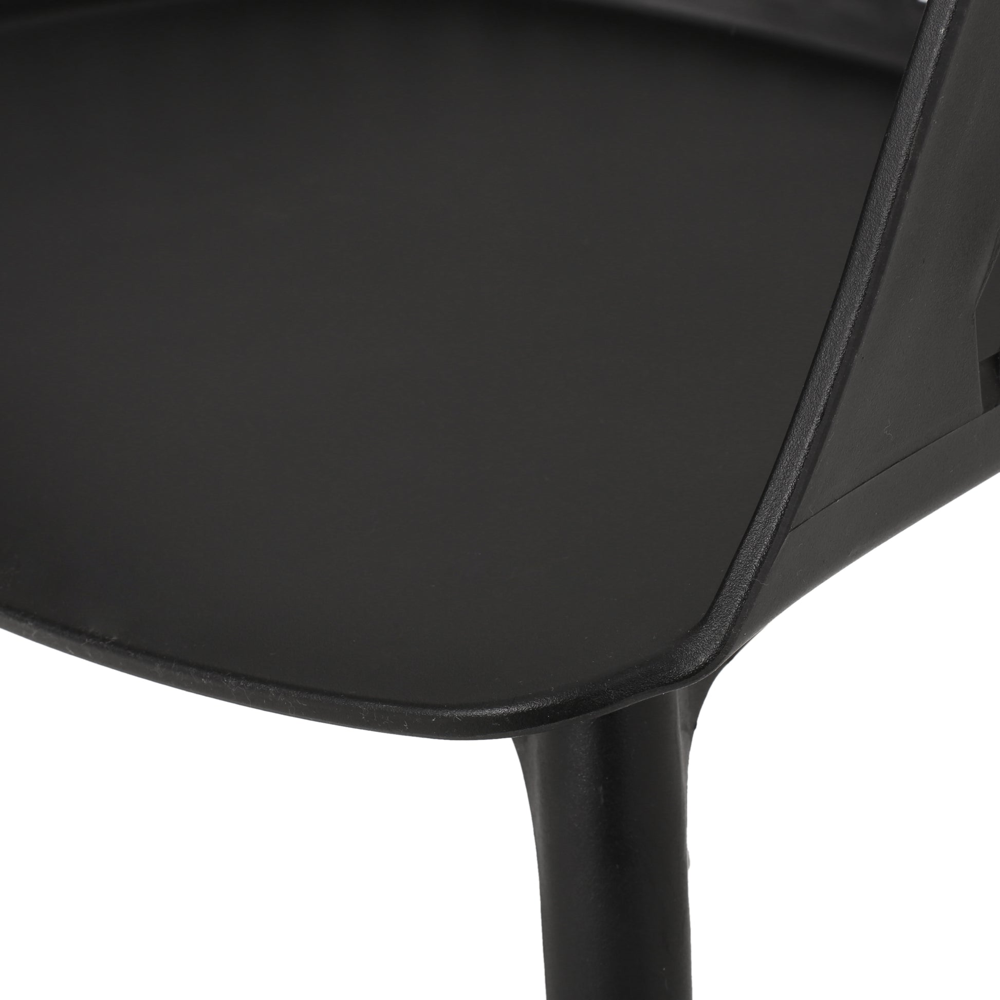 Closeup of a black plastic modern chair seat edge