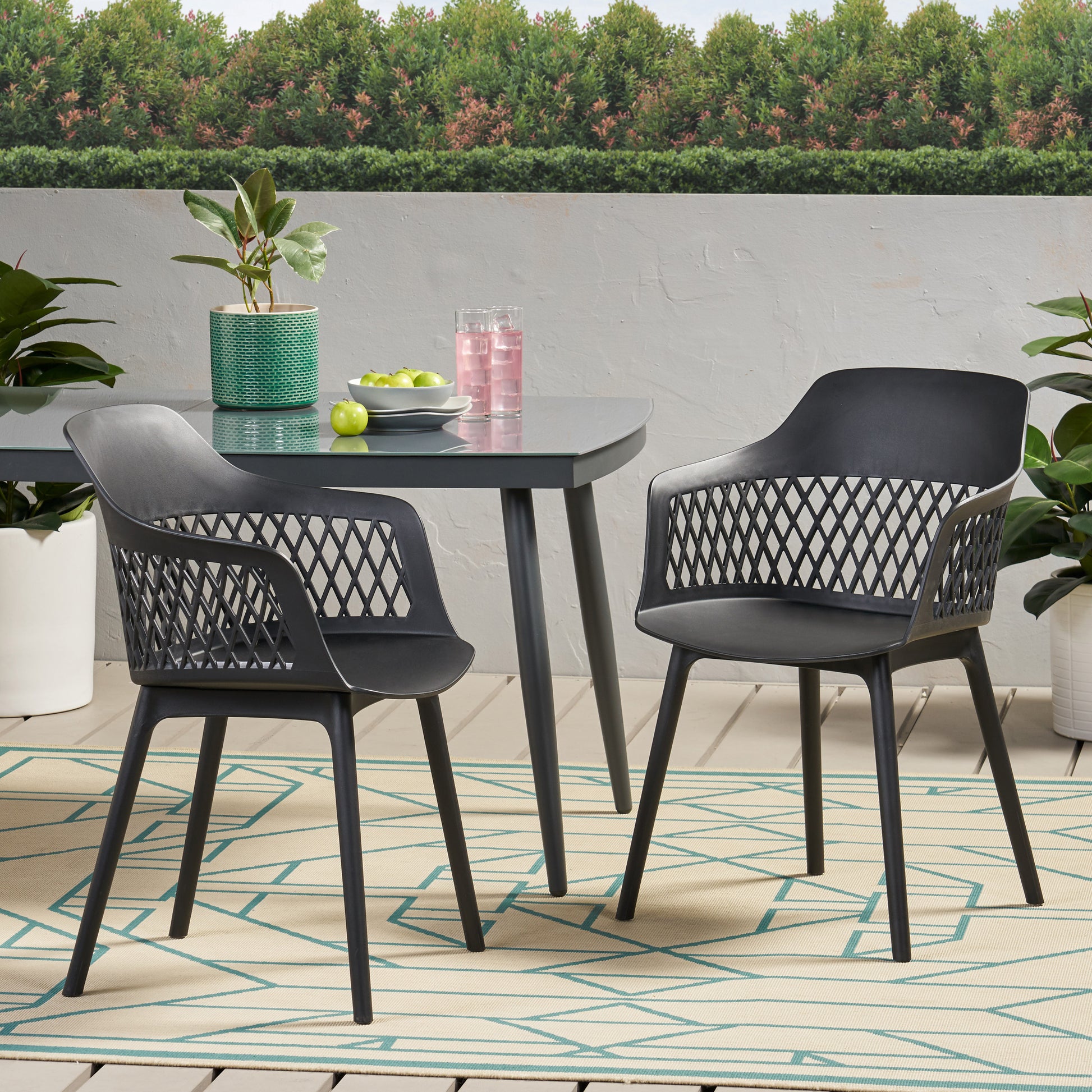 Modern black plastic outdoor armchair with diamondpatterned back and arms
