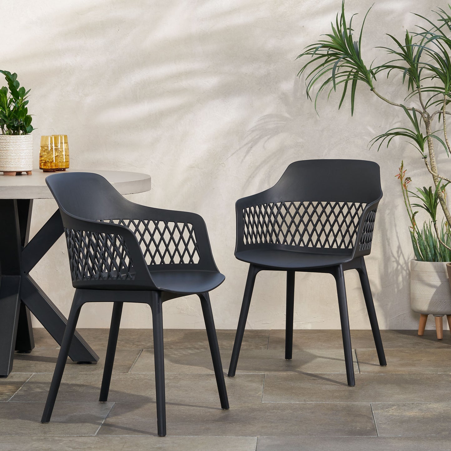 Modern black plastic outdoor dining chair with open diamond pattern backrest