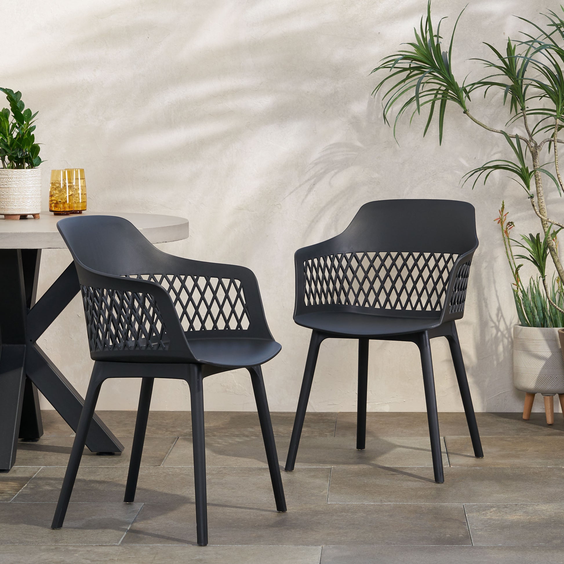 Modern black plastic outdoor dining chair with open diamond pattern backrest