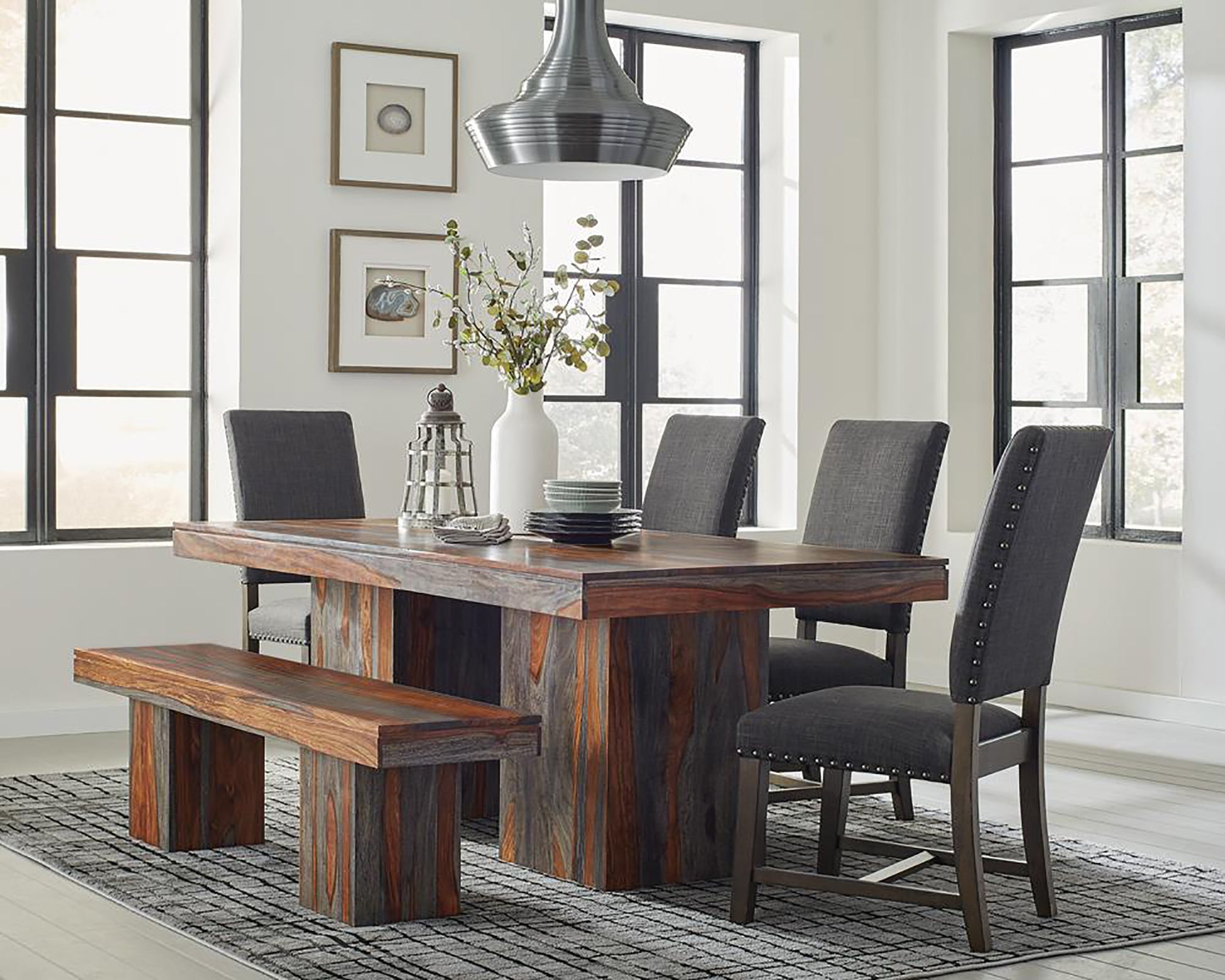 Wooden dining table with rustic finish and upholstered chairs seats six