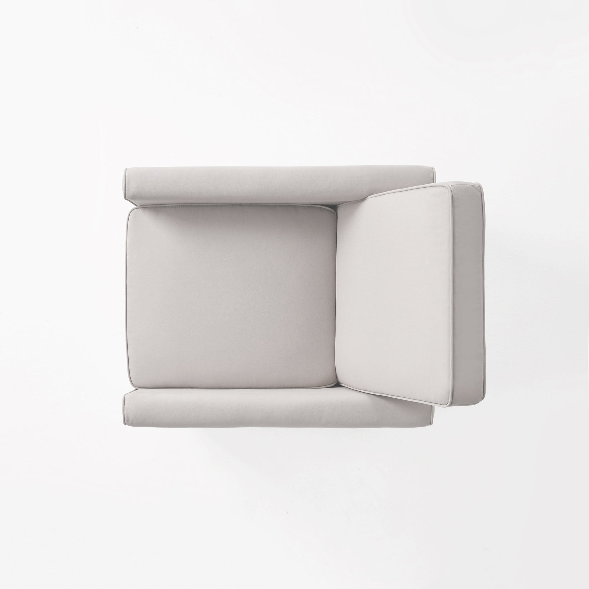 Topdown view of a light grey sectional sofa with piped edges