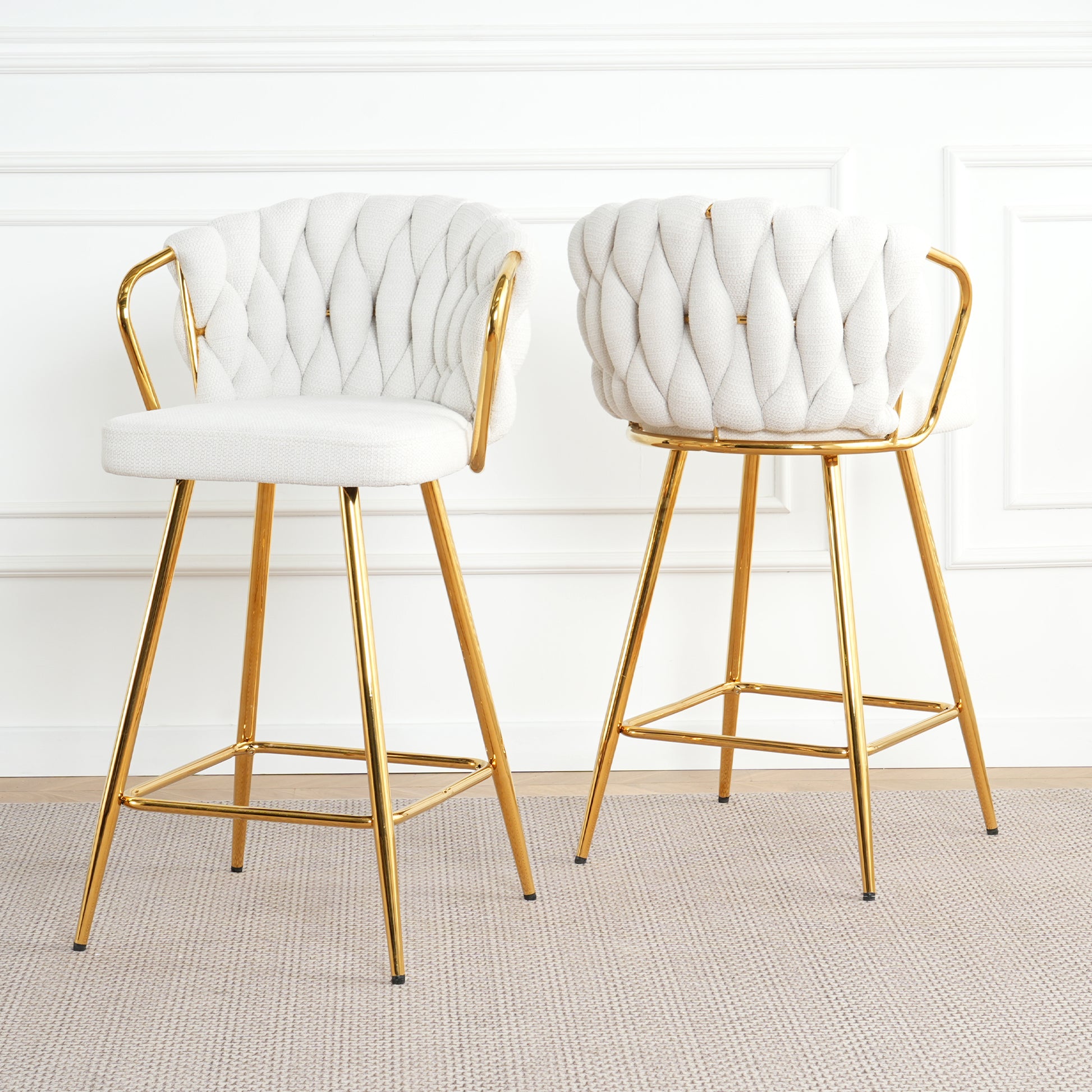 Two white textured fabric bar stools with gold metal legs and arms