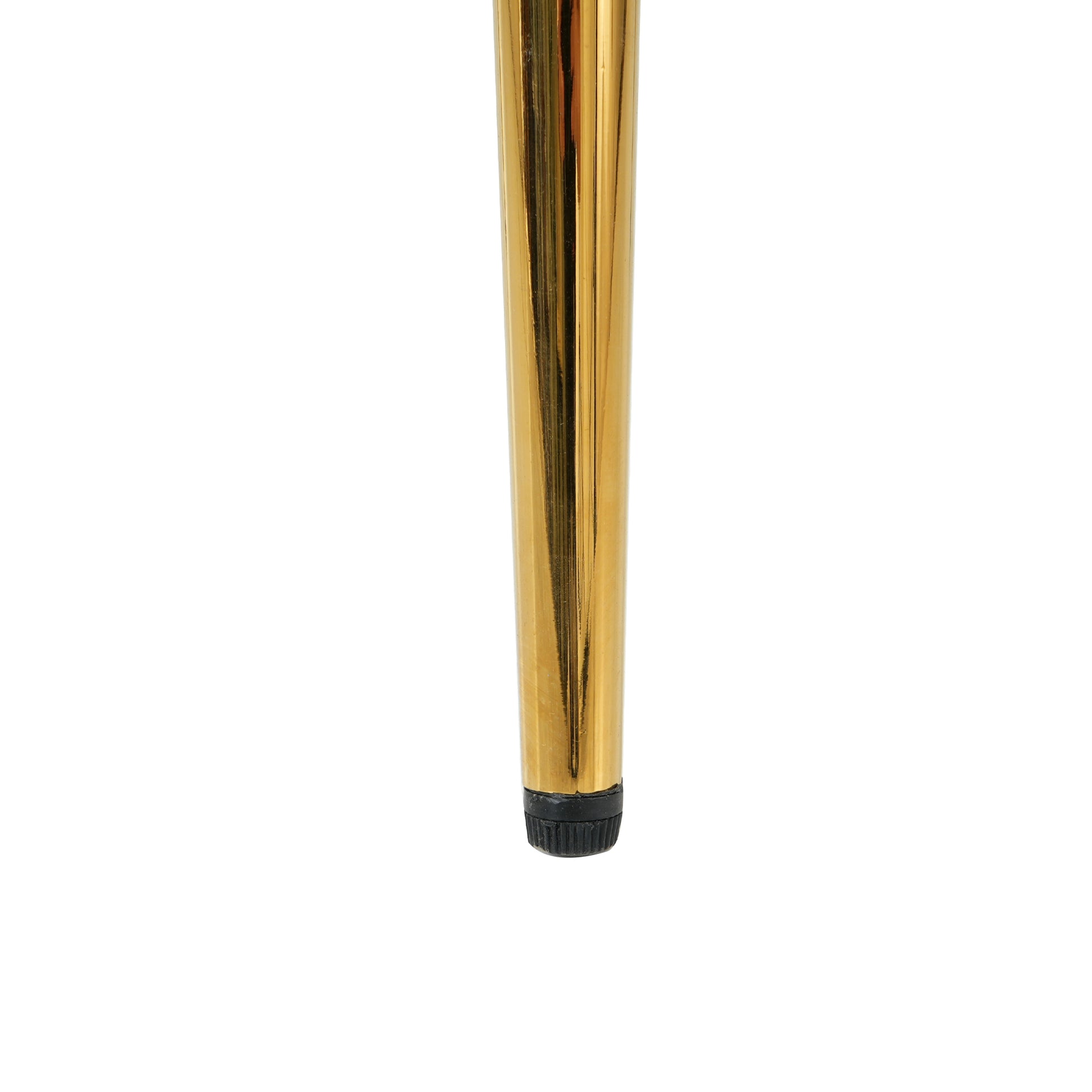 Closeup of a tapered glossy gold metal furniture leg with a black rubber foot