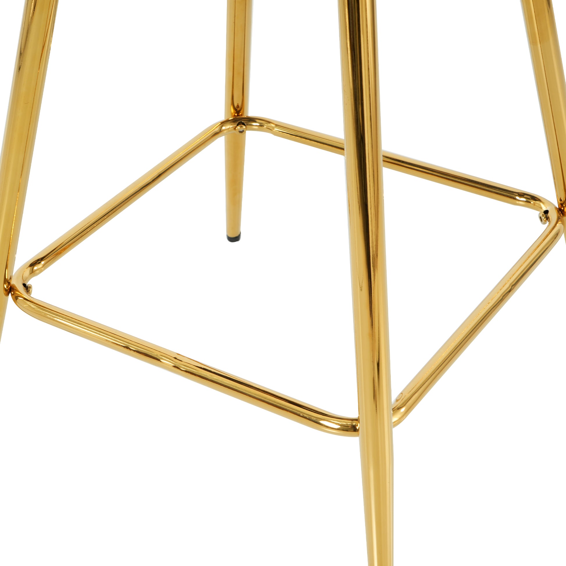 Closeup of the polished gold metal frame and legs of a modern bar stool