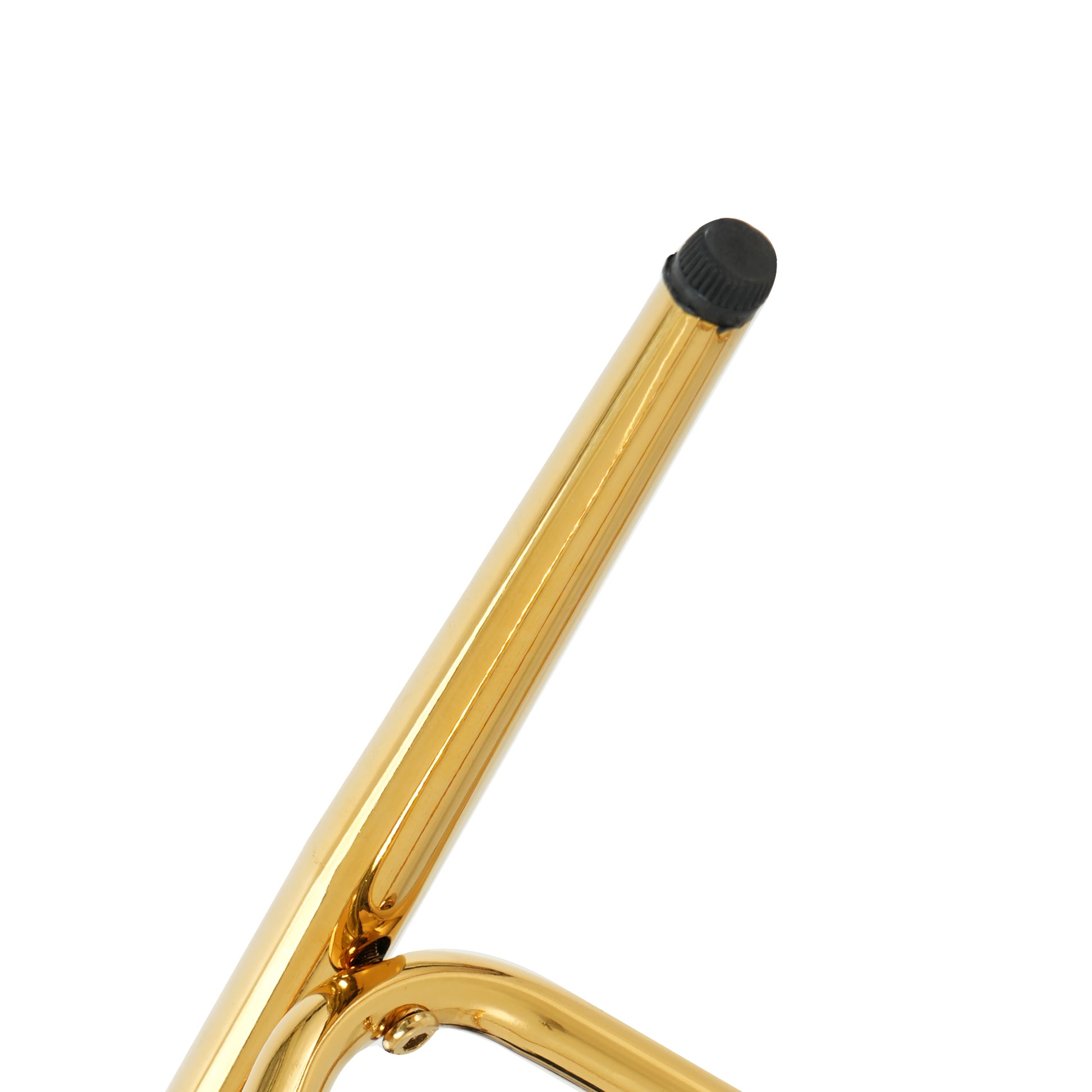 Closeup of a polished gold metal chair leg with a black protective cap on the end