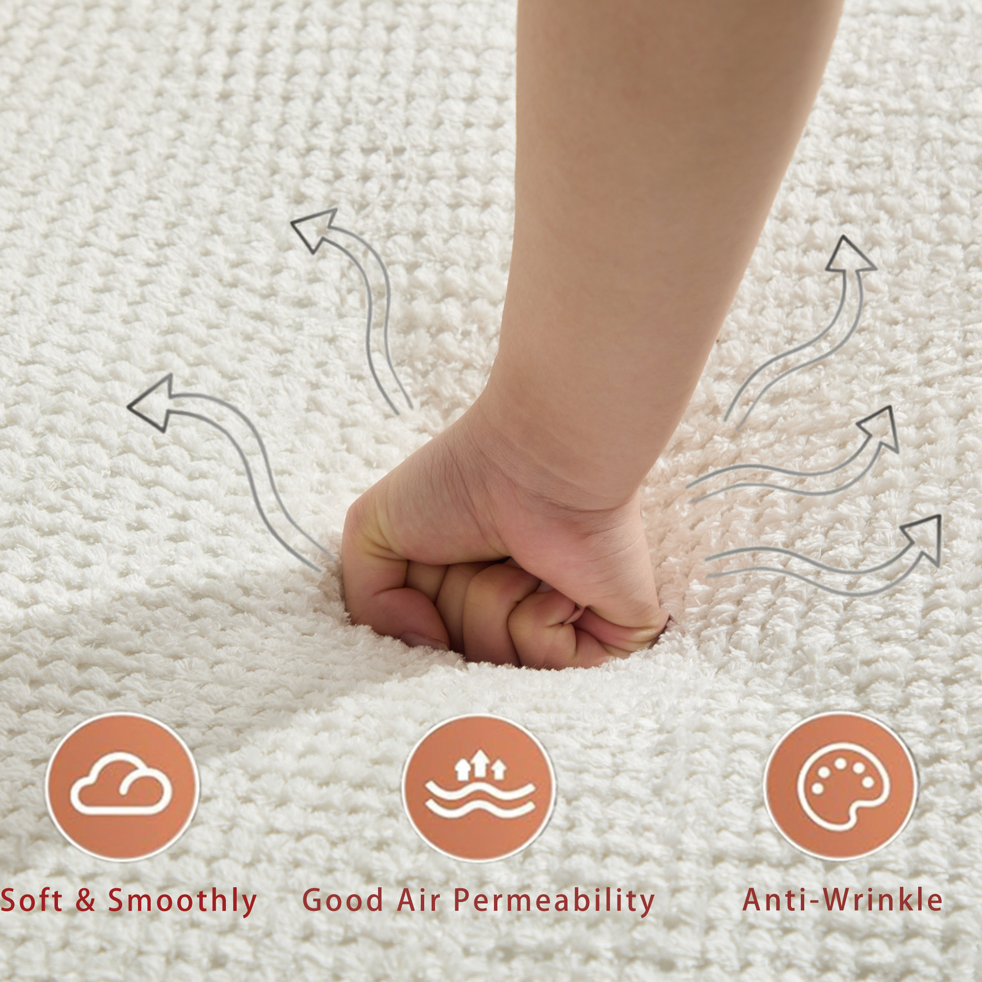 A hand presses into a plush white rug showcasing its soft texture