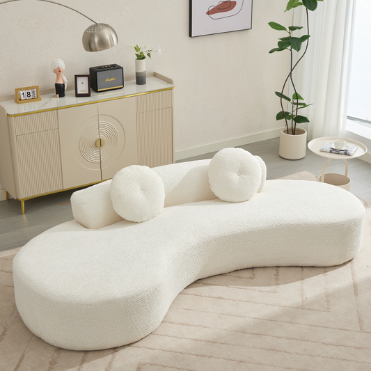 Plush white boucl sectional sofa with curved design and round accent pillows perfect for modern living rooms
