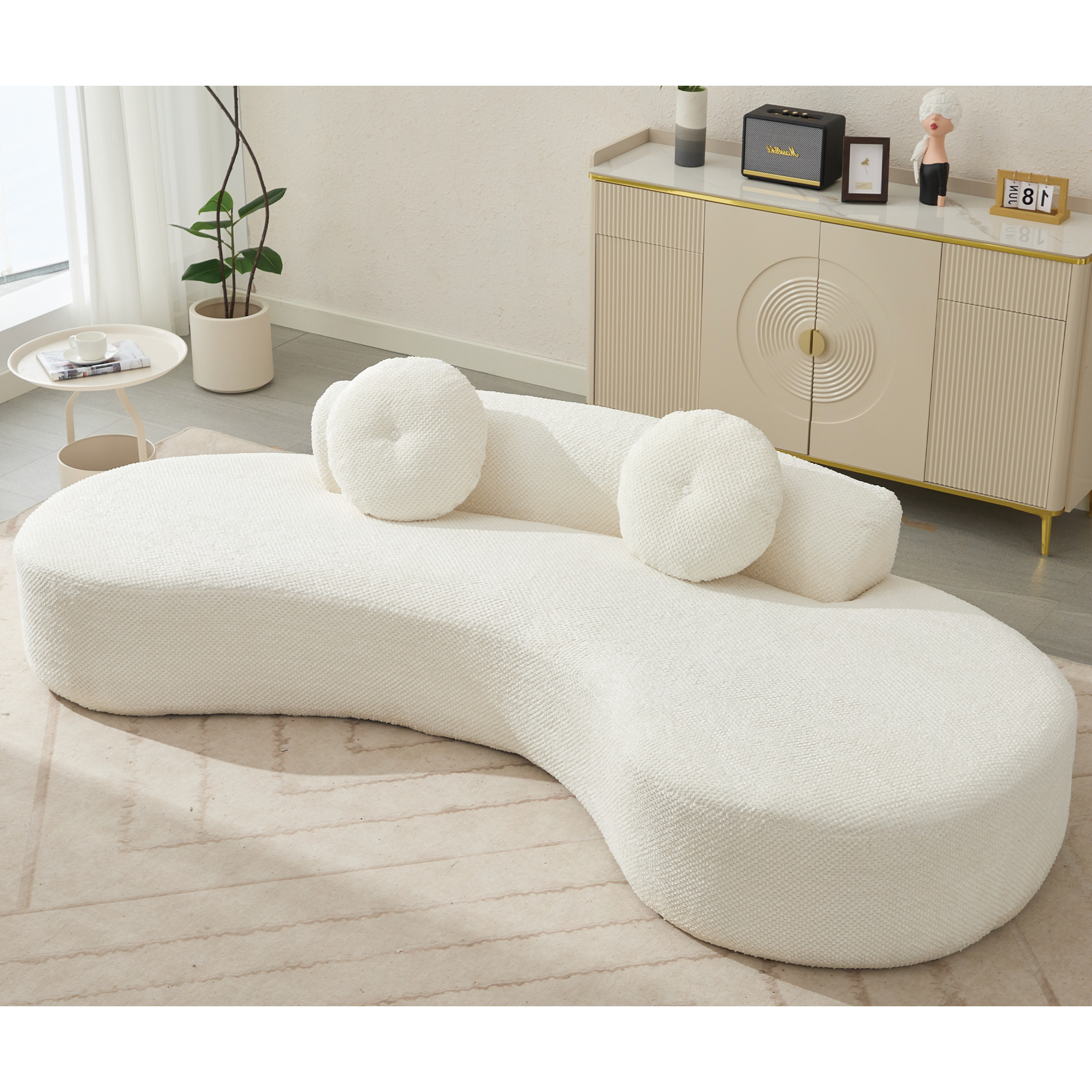 Curved ivory boucle sofa with three matching round accent pillows ideal for modern living spaces